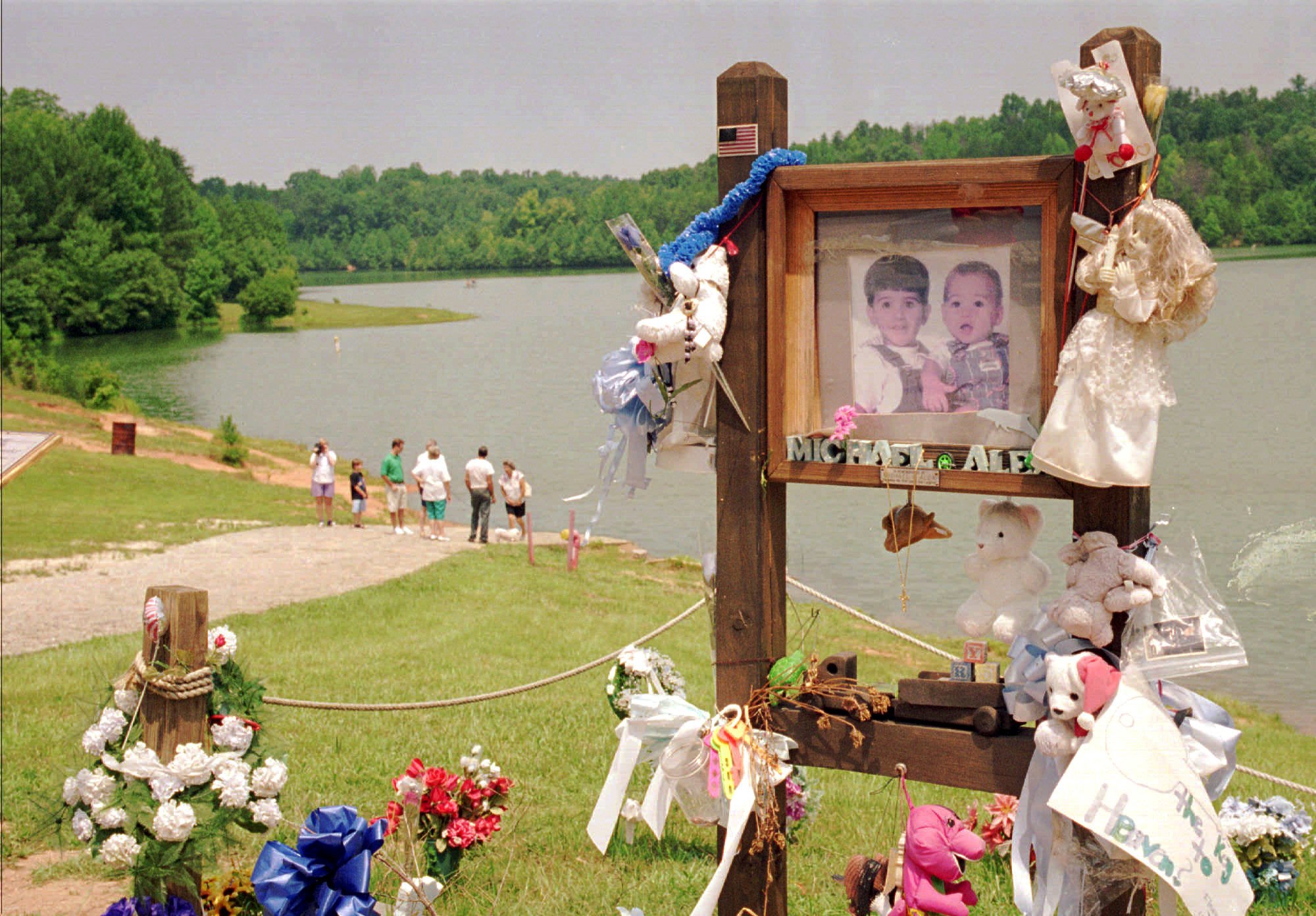 Visitors walk down the ramp where Alex and Michael Smith were drowned in a car in 1994