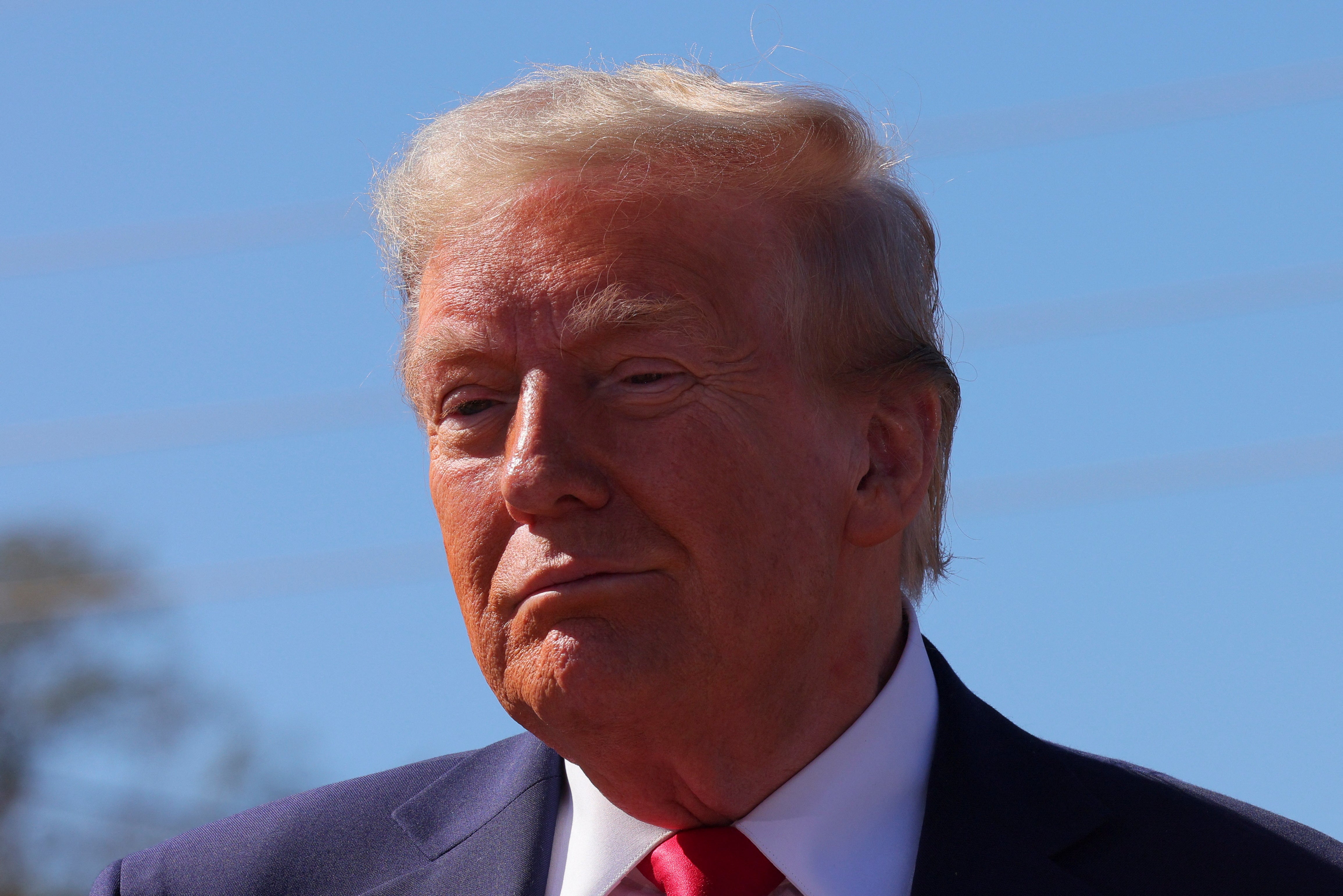 Republican presidential nominee and former U.S. President Donald Trump looks on as he visits a site damaged by Hurricane Helene in Swannanoa, North Carolina, U.S., October 21, 2024. His policies could drain Social Security in just six years, a report has found