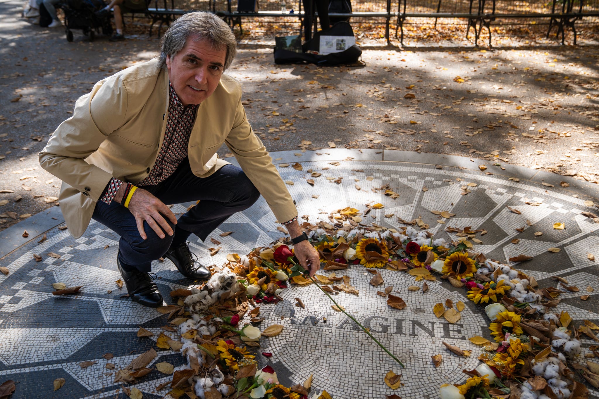 Metro mayor of the Liverpool City Region Steve Rotheram lays a red rose at the Strawberry Fields memorial for John Lennon in New York’s Central Park while on a trade mission to the US (Kevin Matthews/Liverpool City Region Combined Authority/PA)