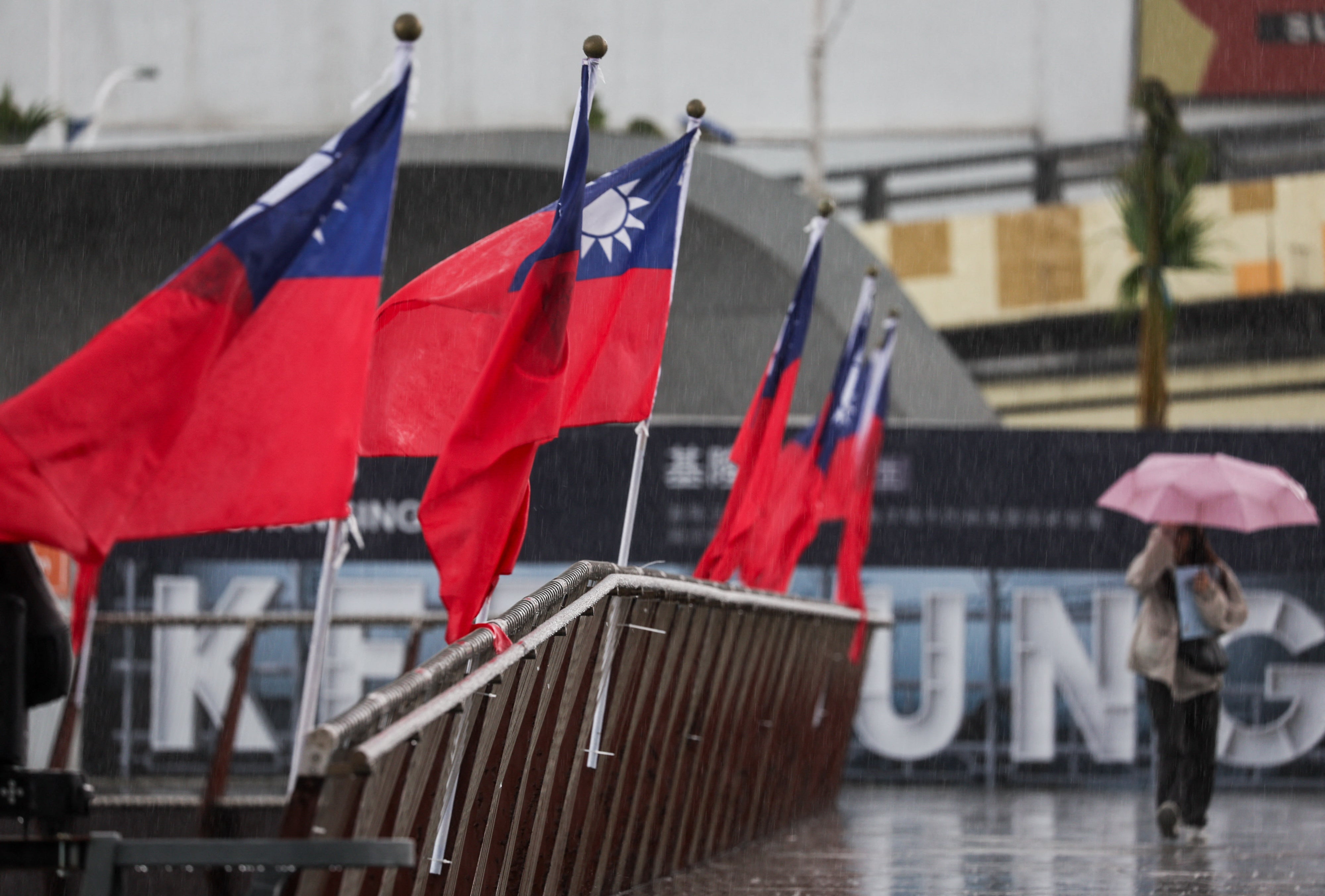 A pistillate   walks past   a Taiwanese nationalist  emblem  astatine  Maritime Plaza successful  Keelung connected  22 October 2024. China's subject   began a unrecorded  occurrence  workout  adjacent   Taiwan, maintaining unit   connected  the self-ruled land  aft  staging large-scale drills and President Xi Jinping called for troops to hole   for war