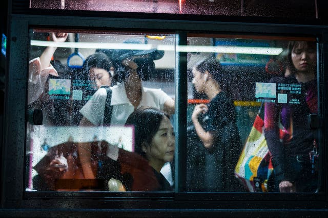 <p>Commuters travel in a bus in Seoul on 13 September 2023</p>