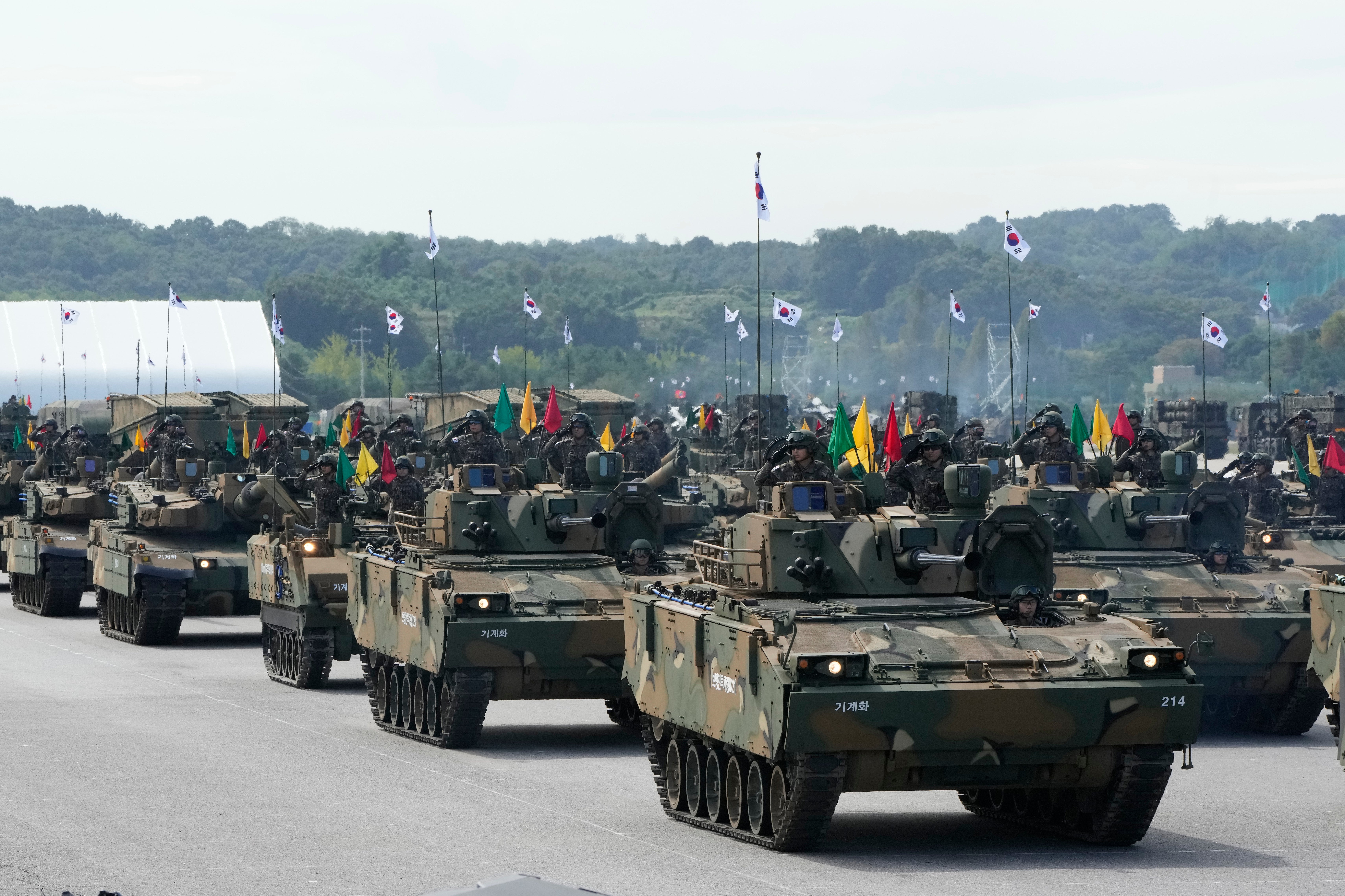 South Korean mechanized unit personnel parade with their armored vehicles