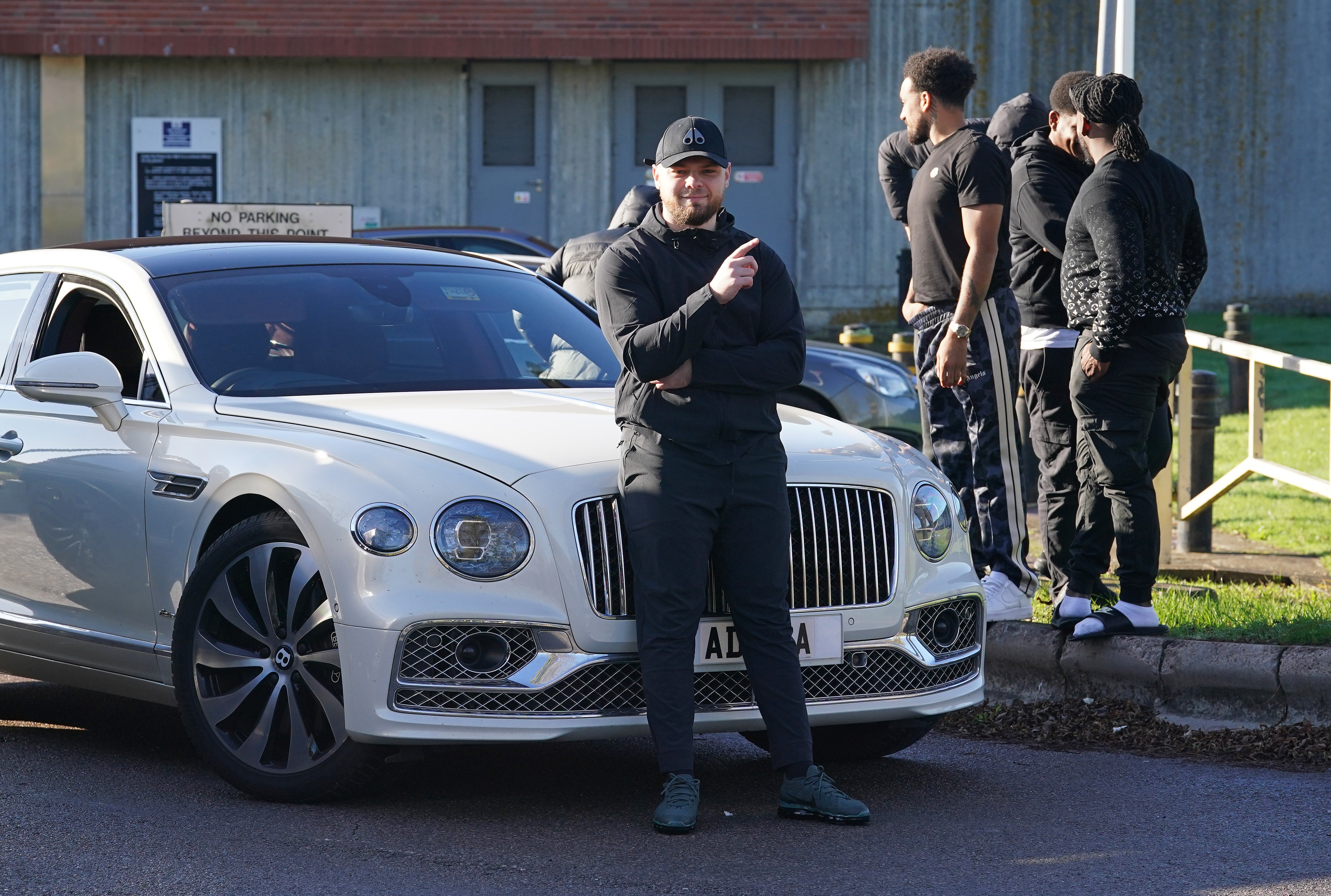 Daniel Dowling-Brooks poses in front of a white Bentley as he celebrates being released outside HM Prison Swaleside on the Isle of Sheppey, Kent