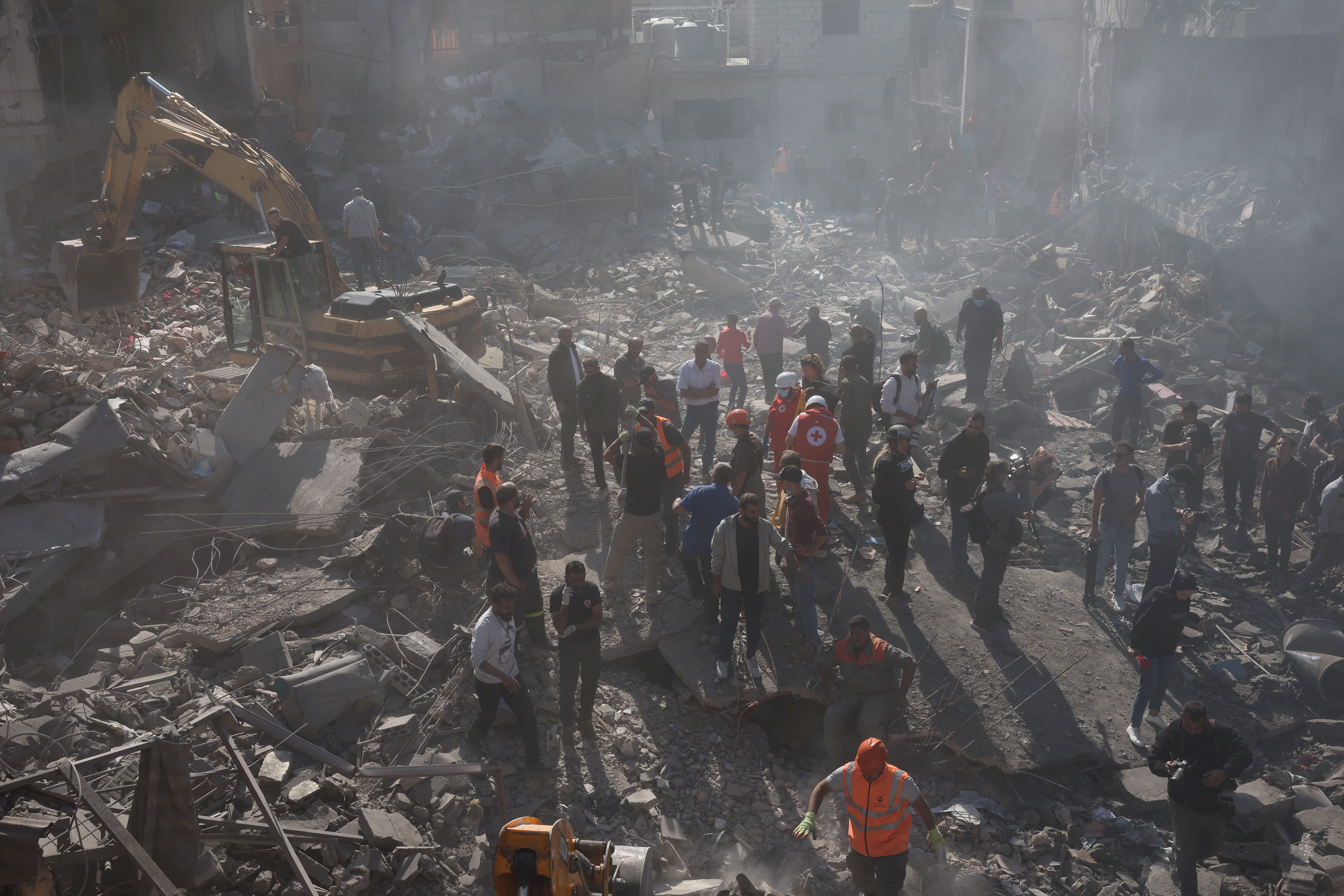 Search and rescue teams search through the rubble after an Israeli strike