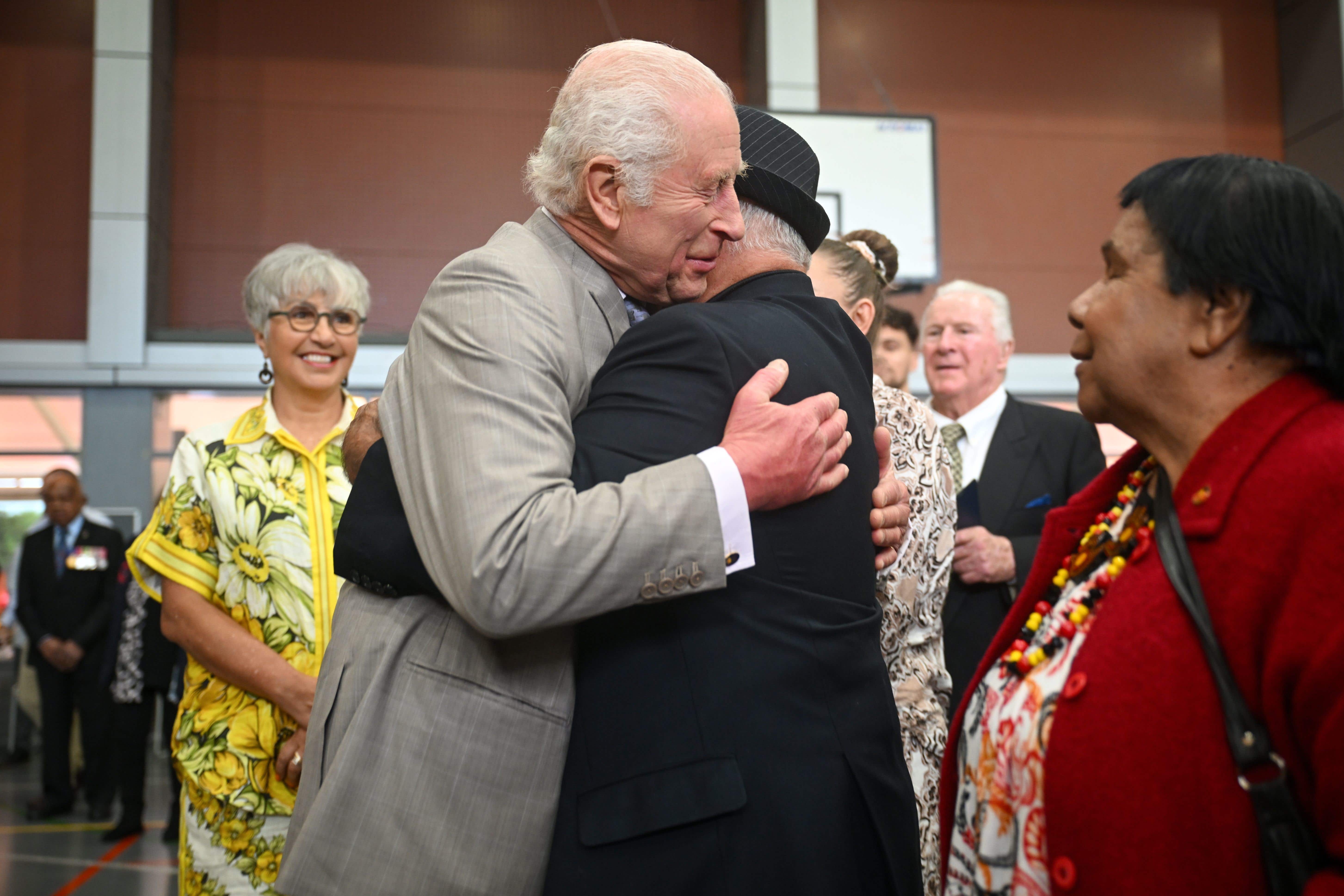 The King hugs Uncle James Michael Welsh during a meeting with members of the Indigenous community in Australia (Victoria Jones/PA)