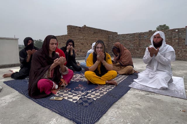 <p>A Muslim cleric and transgender persons attend a prayer ceremony for their colleagues, who were killed by two men armed with daggers at their home, in Mardan, a city in Pakistan's Khyber Pakhtunkhwa province</p>