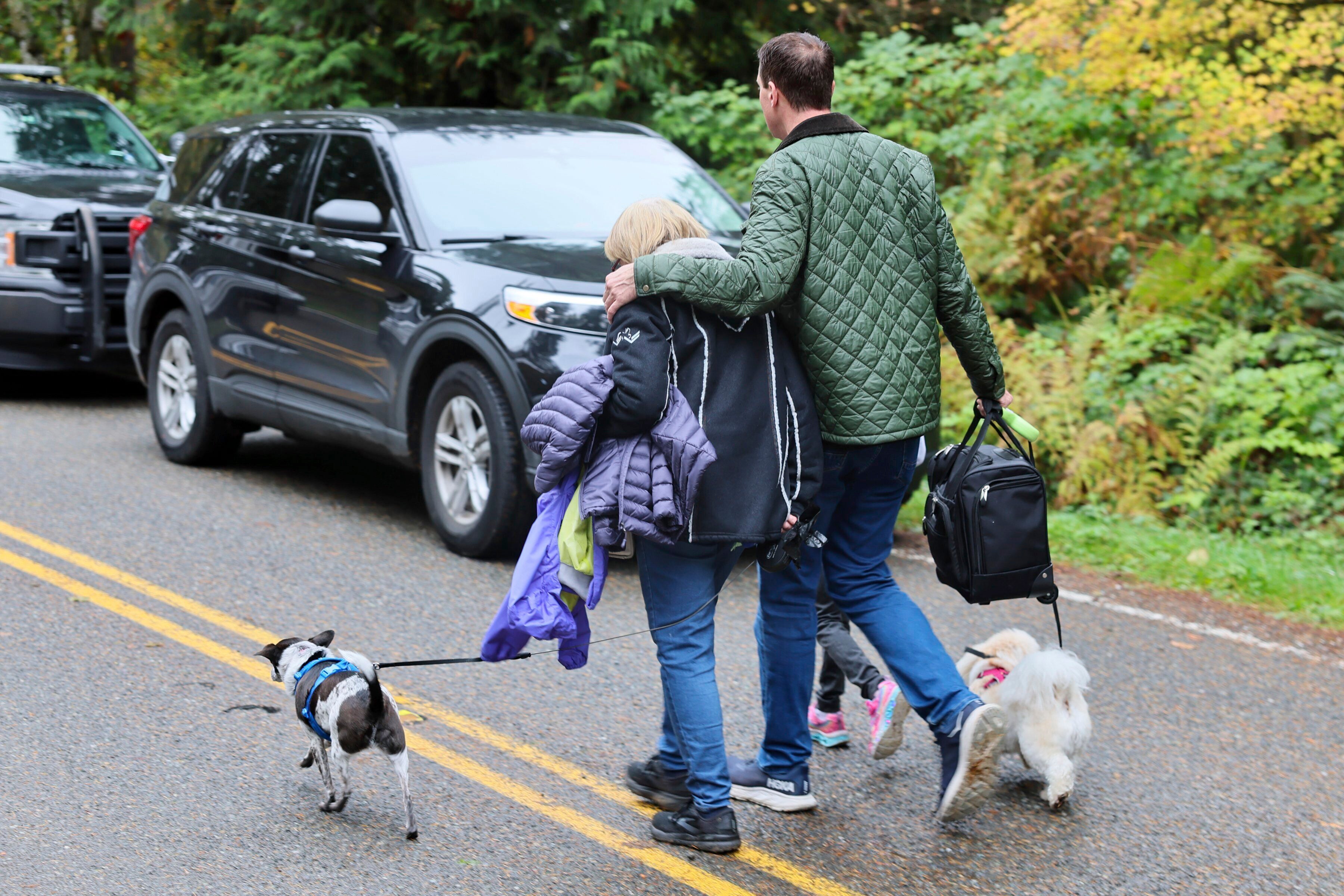 Neighbors leave the scene of the fatal shooting Monday morning