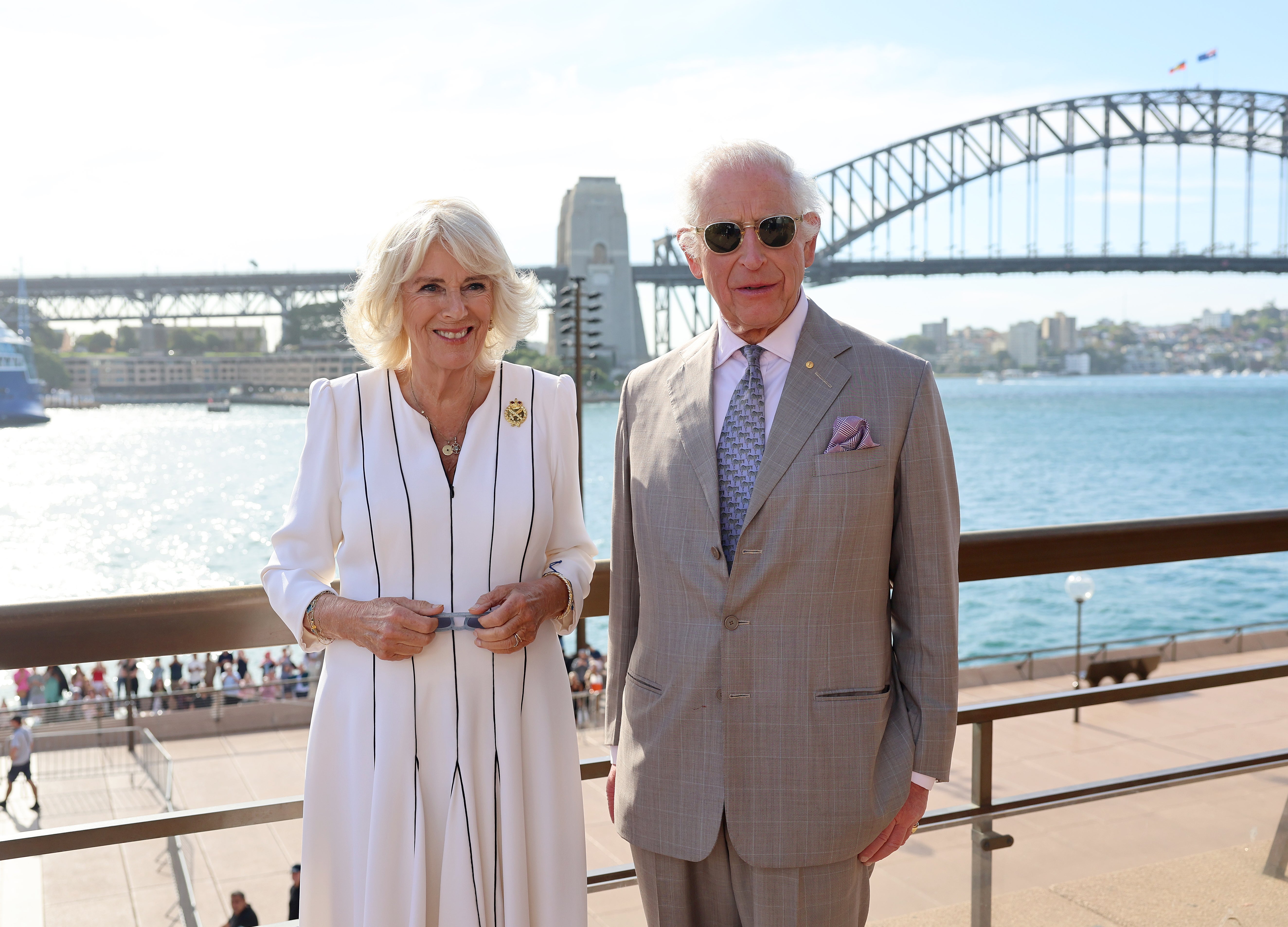 King Charles and Queen Camilla pose for a photo in front of the Sydney Harbour Bridge