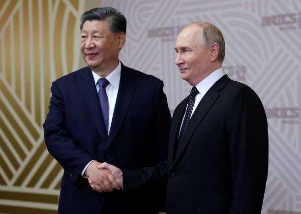 Russian president Vladimir Putin greets Chinese president Xi Jinping during a welcoming ceremony for participants of the Brics summit