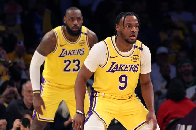 <p>Bronny James (front) stepped on the court in the second quarter to play alongside his dad LeBron (back) during the LA Lakers’s season opener </p>