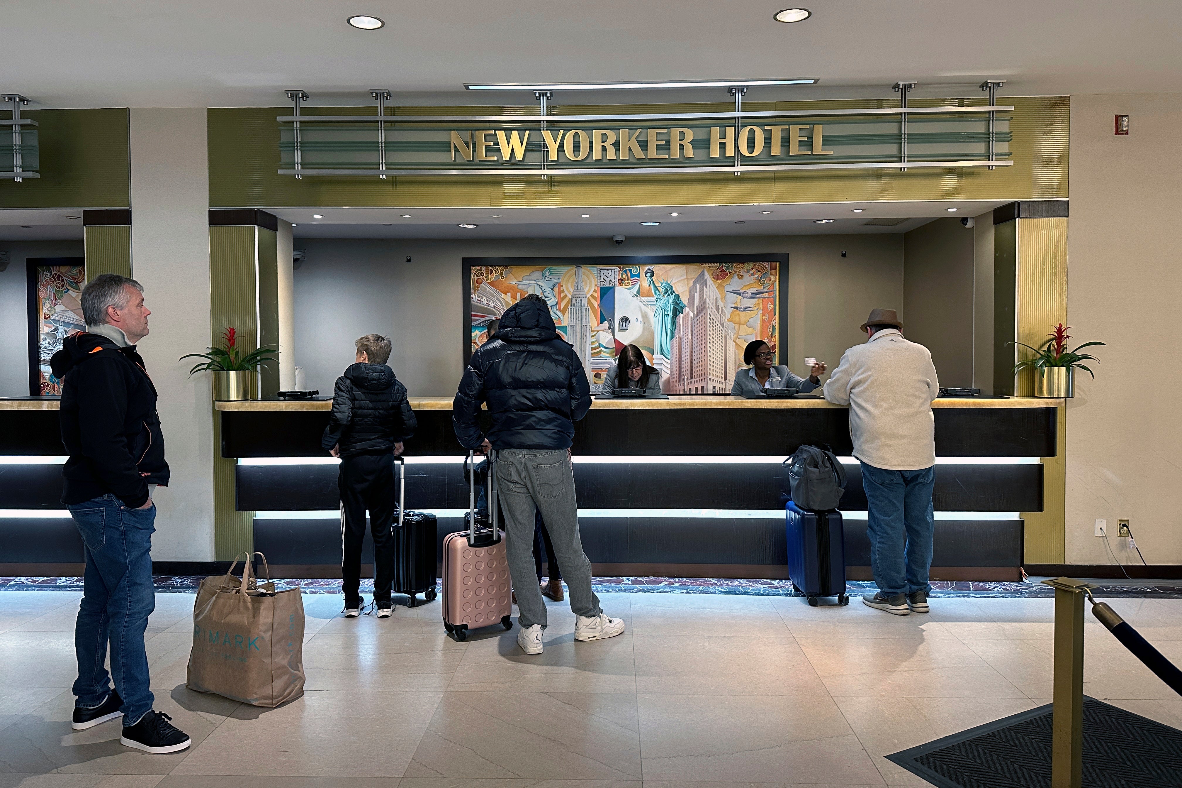 People check into the New Yorker Hotel in New York on Sunday, Feb. 18, 2024