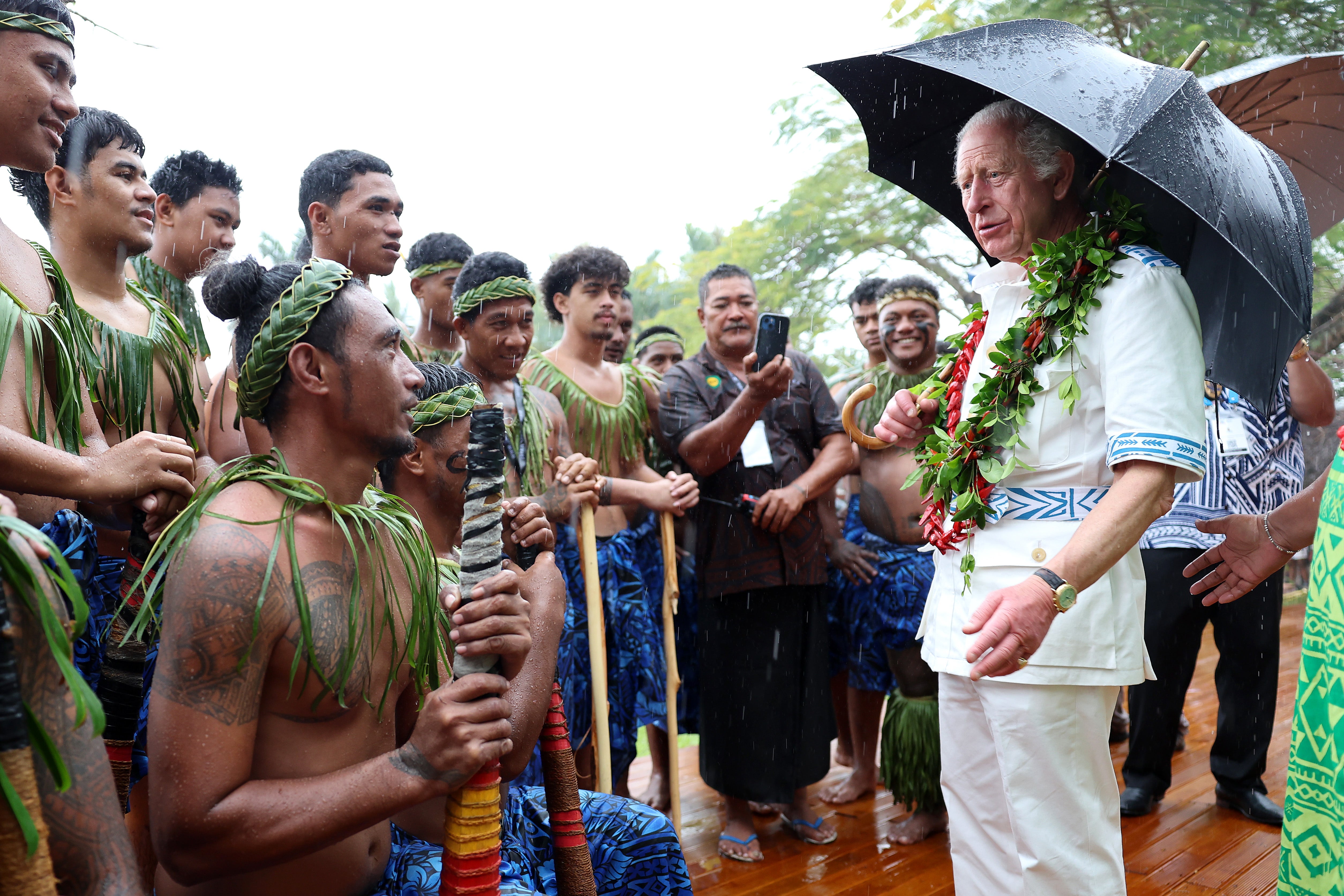 King Charles speaks to local villagers during his Samoa Cultural Village visit on 24 October 2024 in Apia, Samoa