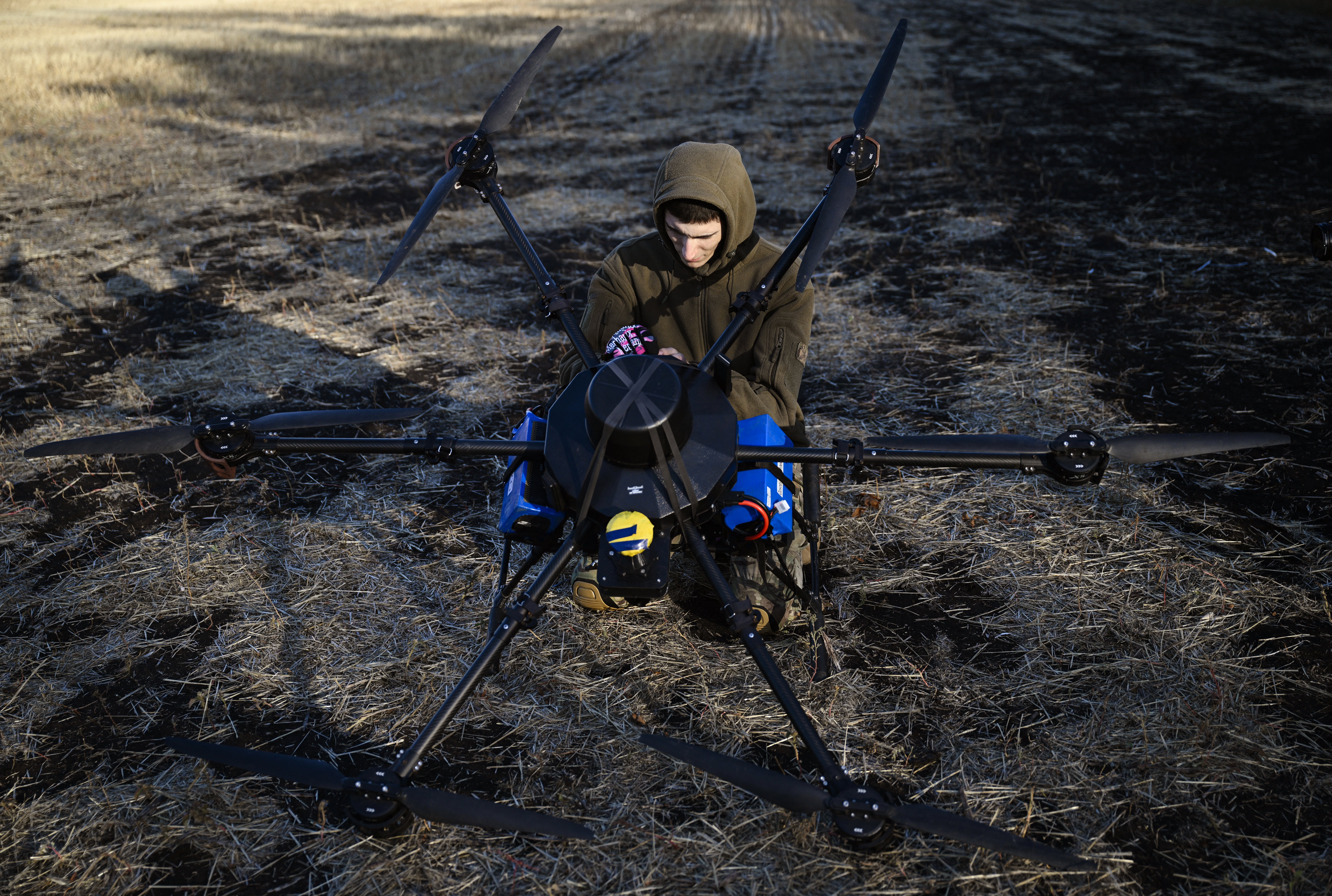 A Ukrainian serviceman of the 30th separate mechanised brigade prepares to run tests flights of a hexacopter drone ahead of battle mission