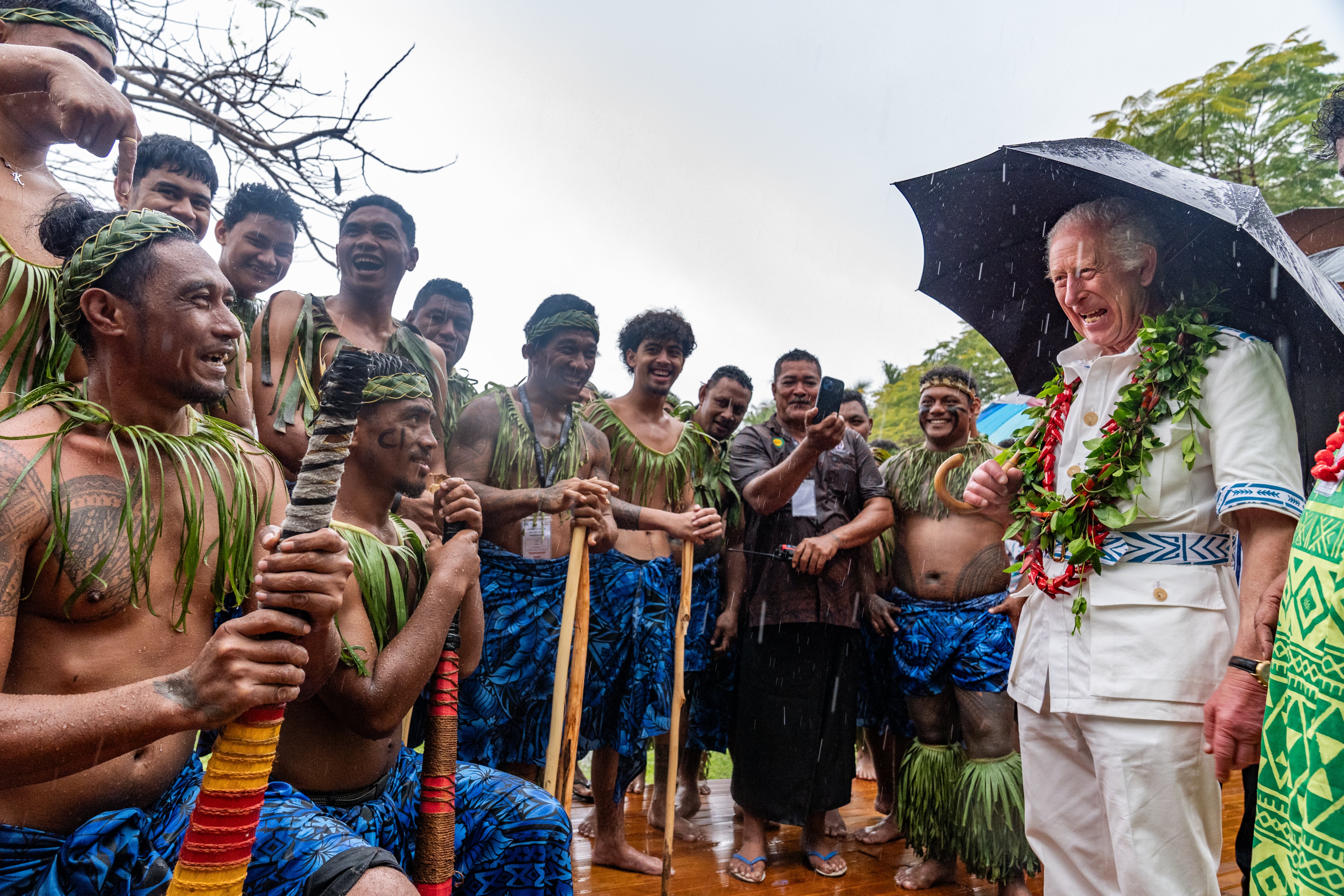 King Charles shares a joke with members of a cricket team in Samoa