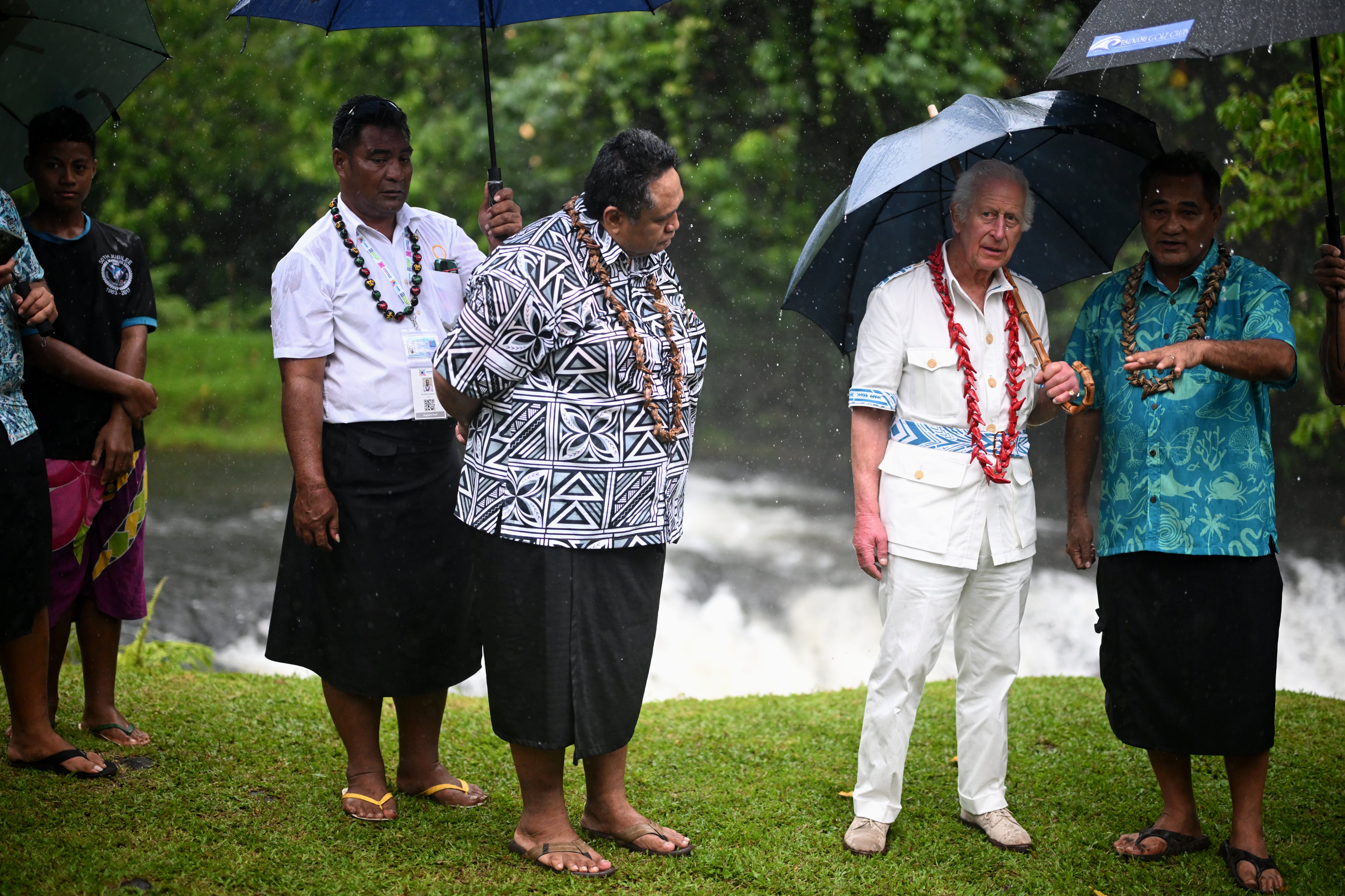 King Charles shelters from the rain in the O Le Pupu’Pue National Park on the island of Upolu