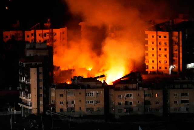 <p>Flame and smoke rises from buildings hit by Israeli airstrikes in the southern suburb of Beirut</p>