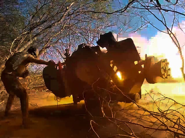 <p>In this image taken from video released by the Russian Defense Ministry, a Russian soldier fires a gun toward Ukrainian positions</p>