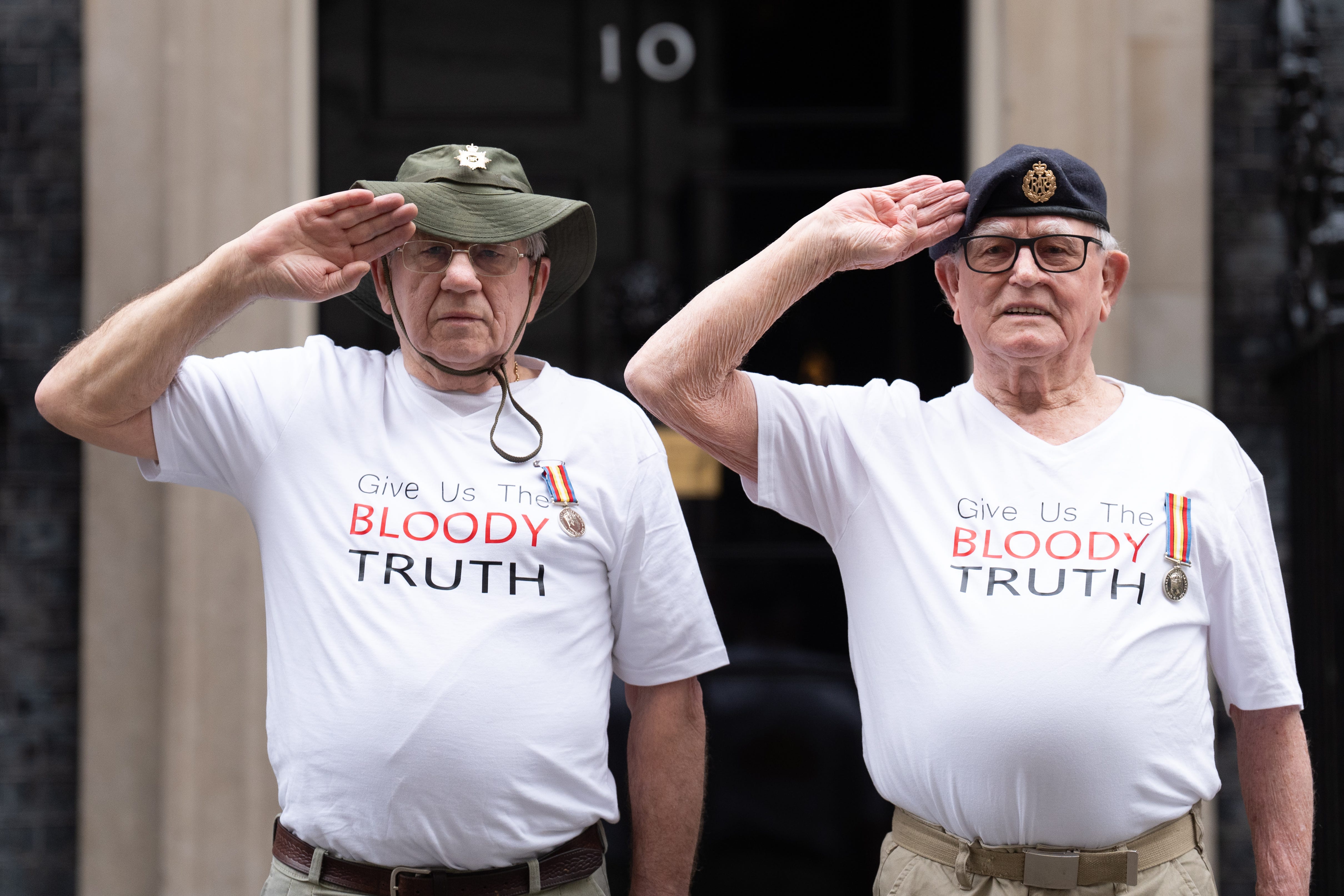 Veterans of Britain’s Cold War radiation experiments Terry Quinlan and Brian Unthank hand a petition in at Downing Street (Stefan Rousseau/PA)