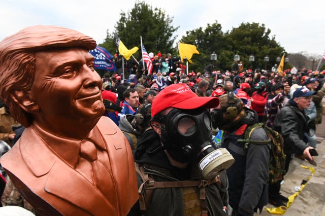 <p>Victory or bust: supporters of Donald Trump don gas masks and Maga hats in their attack on Capitol Hill on 6 January 2021 </p>