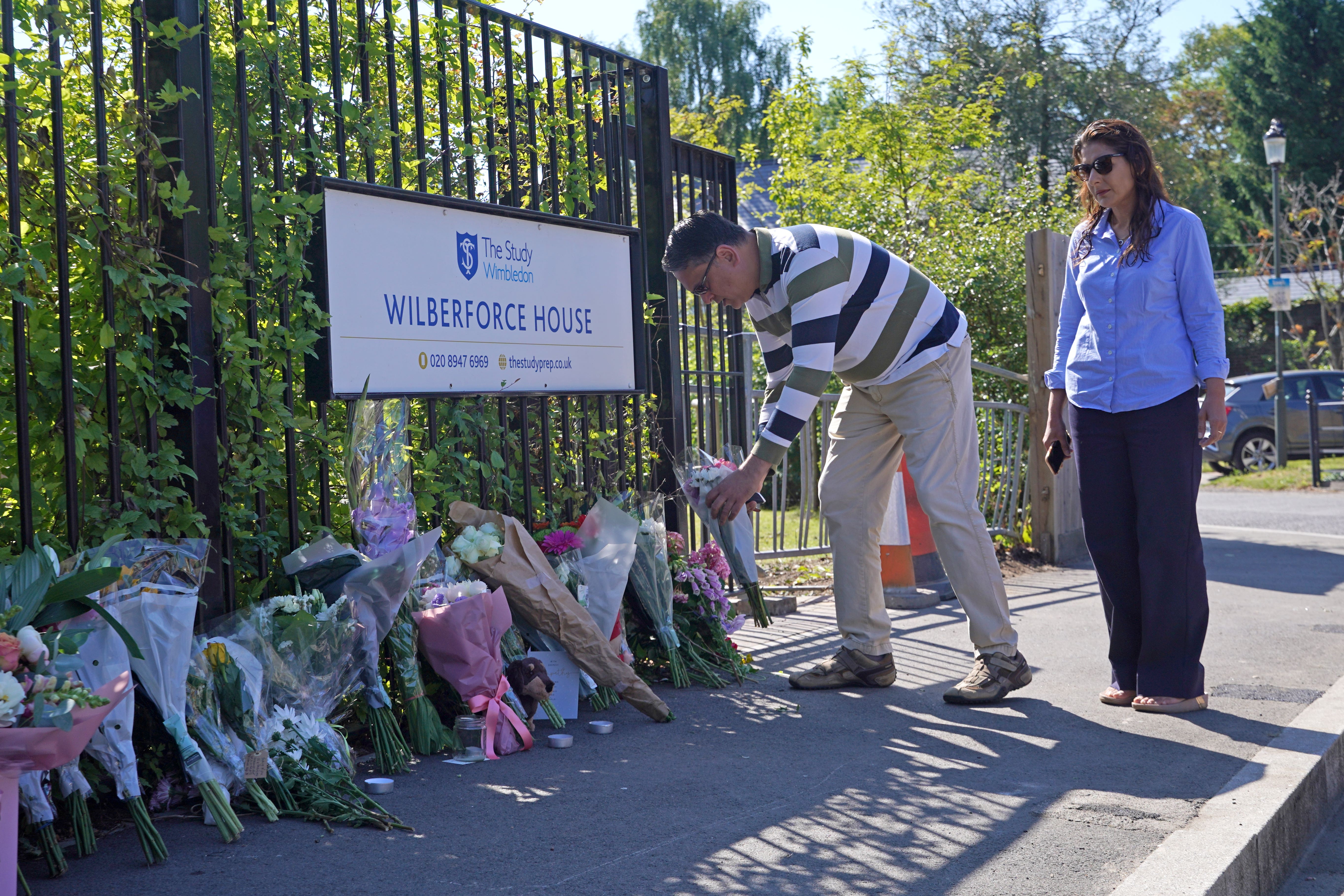 Mourners leave flowers and tributes for the girls outside Study Prep school in Wimbledon