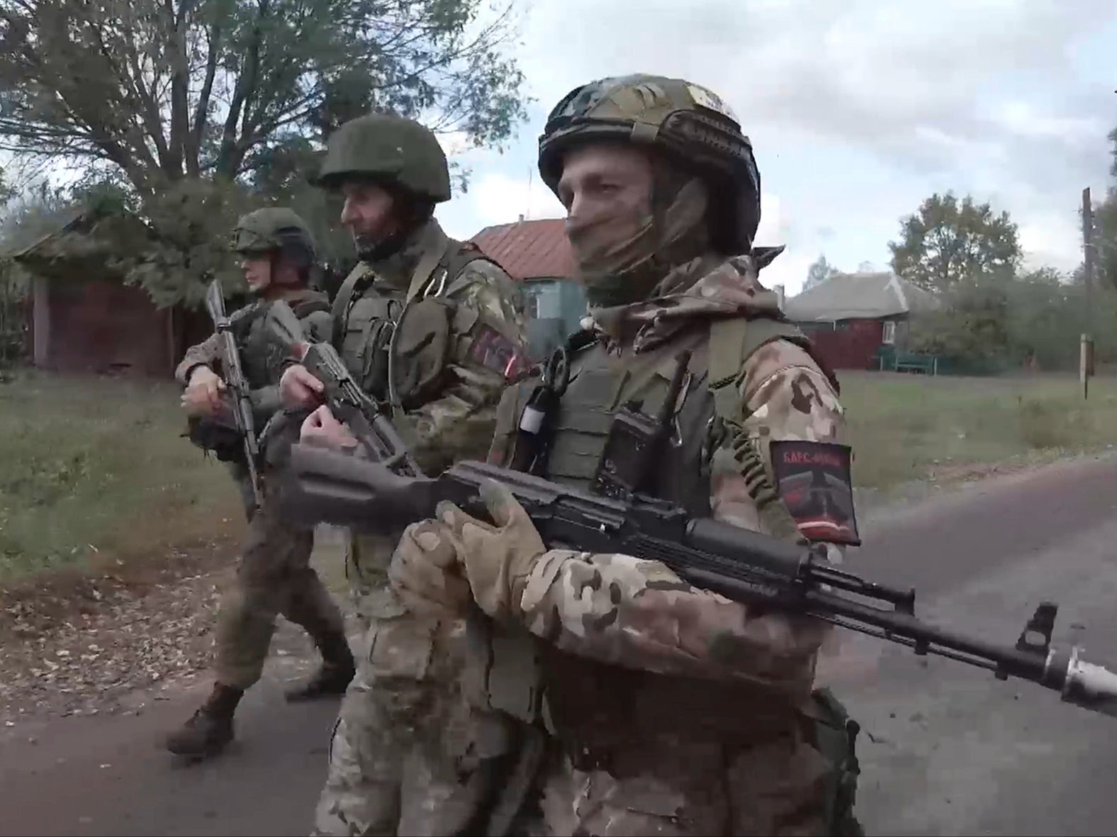 In this photo taken from video released by the Russian Defense Ministry, Russian soldiers patrol a village in the Russian - Ukrainian border area in the Kursk region, Russia