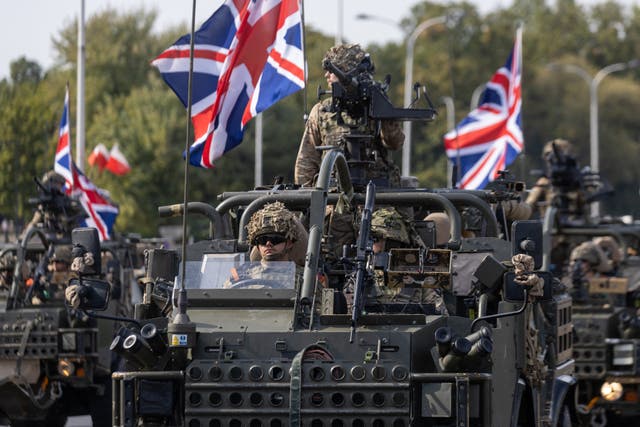 <p>British soldiers take part in a military parade in Warsaw last August </p>