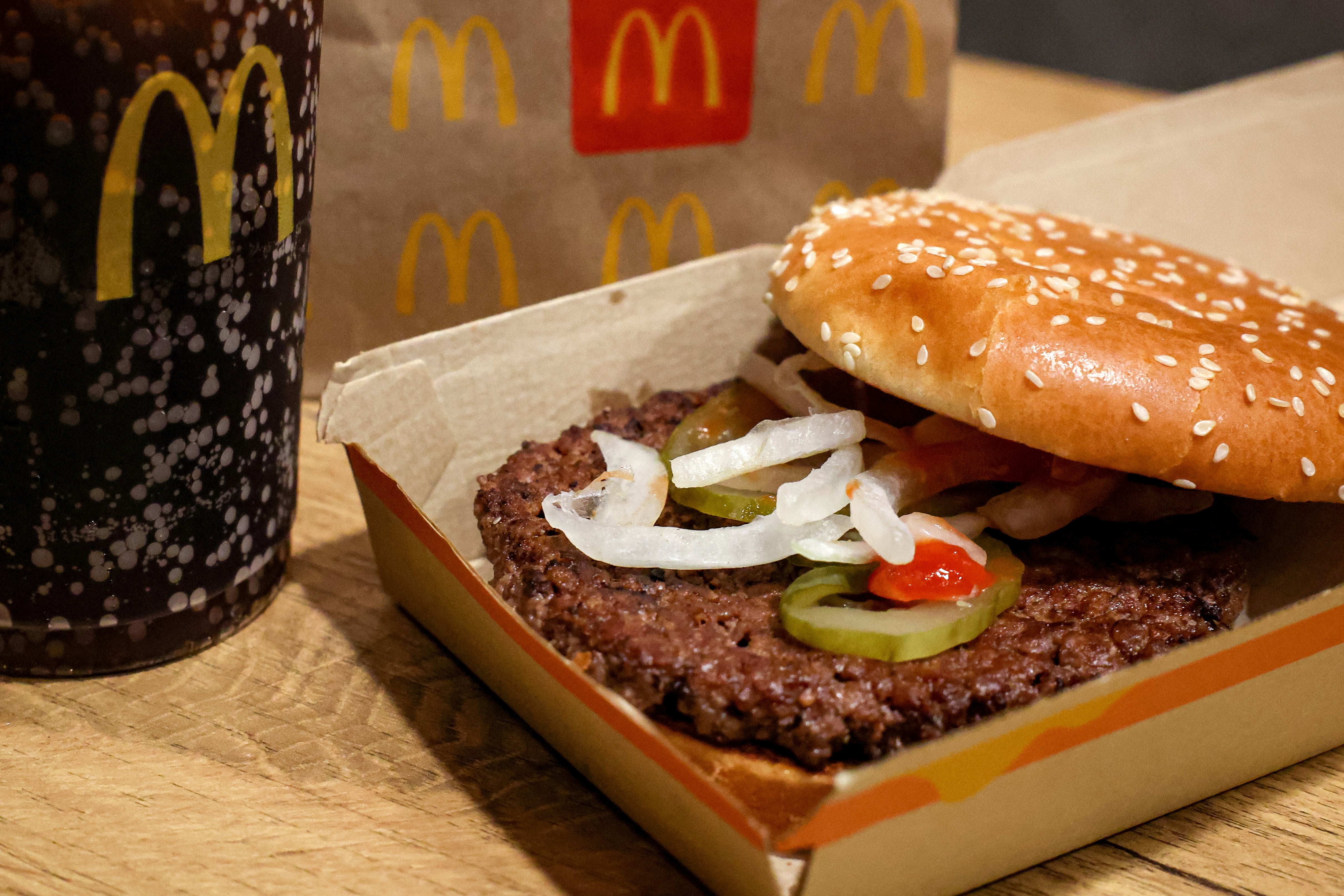 A McDonald's Quarter Pounder hamburger and a soda sit on a table New York City on Thursday. In response to the outbreak, health officials say slivered onions and beef patties were pulled from stores in several states.