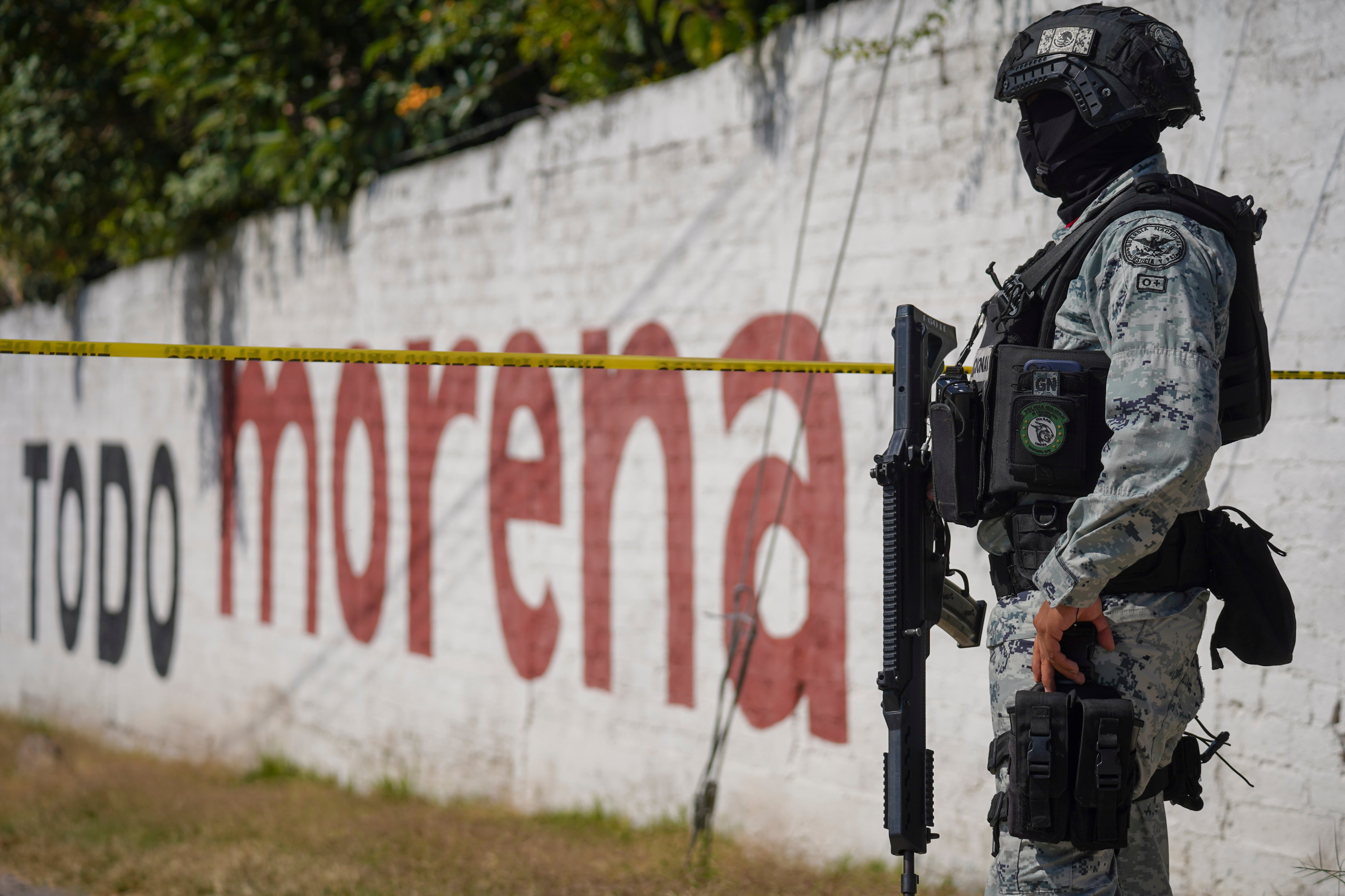 A National Guardsman stand guard over a scene where a car bomb exploded near a police station in Acambaro, Guanajuato