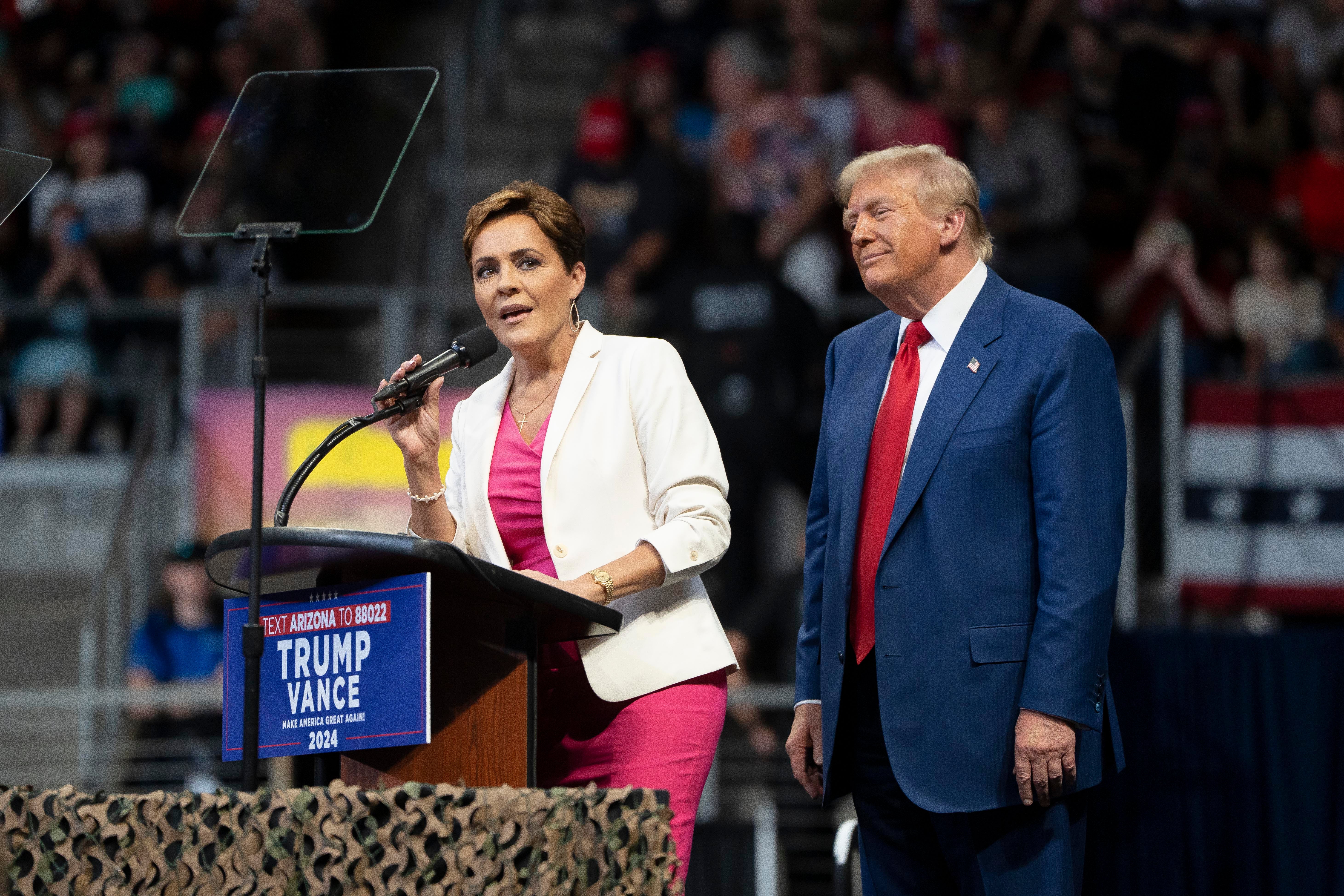 Kari Lake speaks at a campaign rally for Donald Trump in Arizona, where she is running for an open Senate seat against Democratic candidate Ruben Gallego.