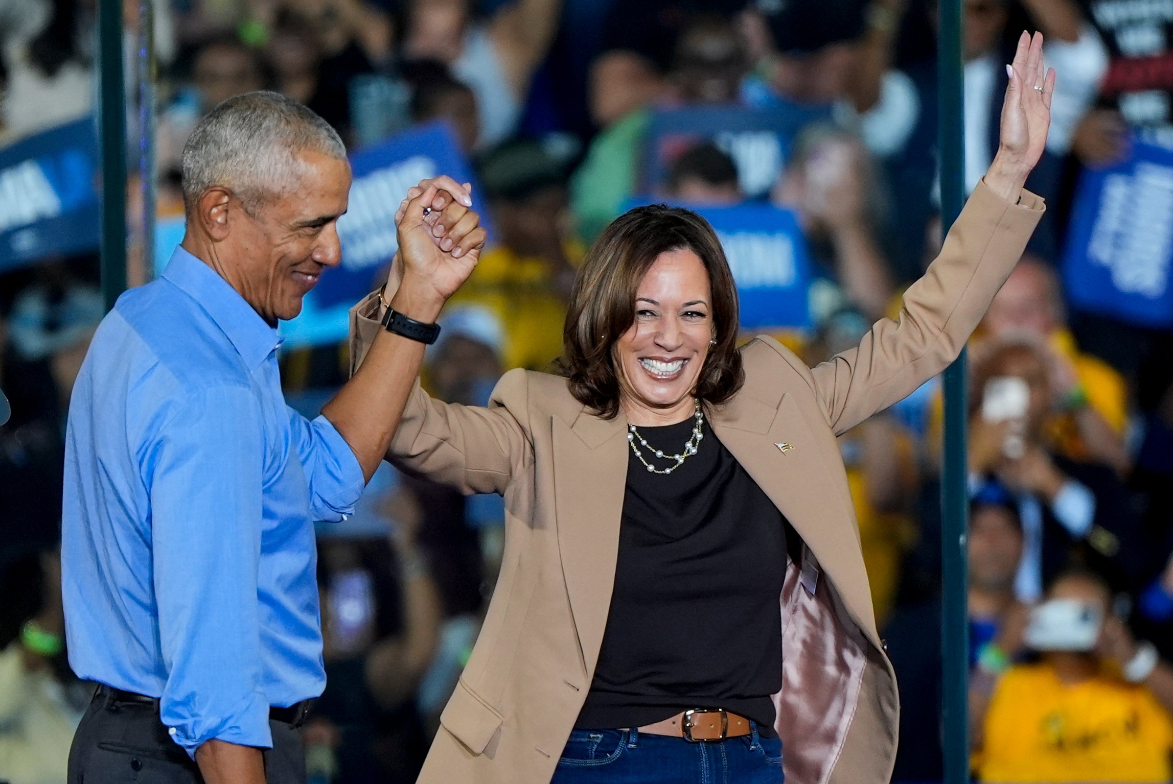 Former President Barack Obama holds hands with Democratic presidential nominee Vice President Kamala Harris after introducing her to speak during a campaign rally for Harris on Thursday, Oct. 24, 2024, in Clarkston, Georgia