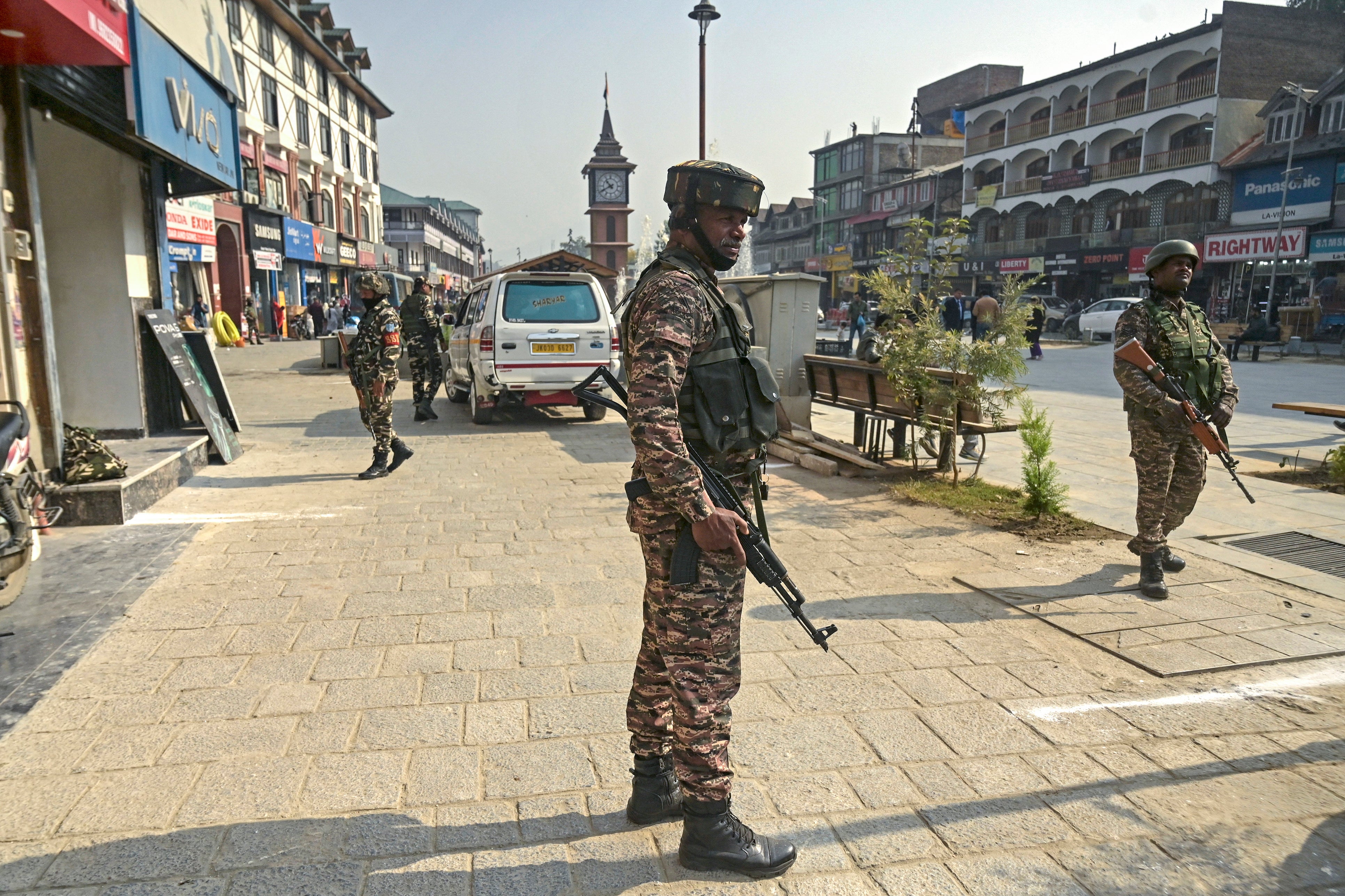 Indian security personnel stand guard along a road in Srinagar, Kashmir