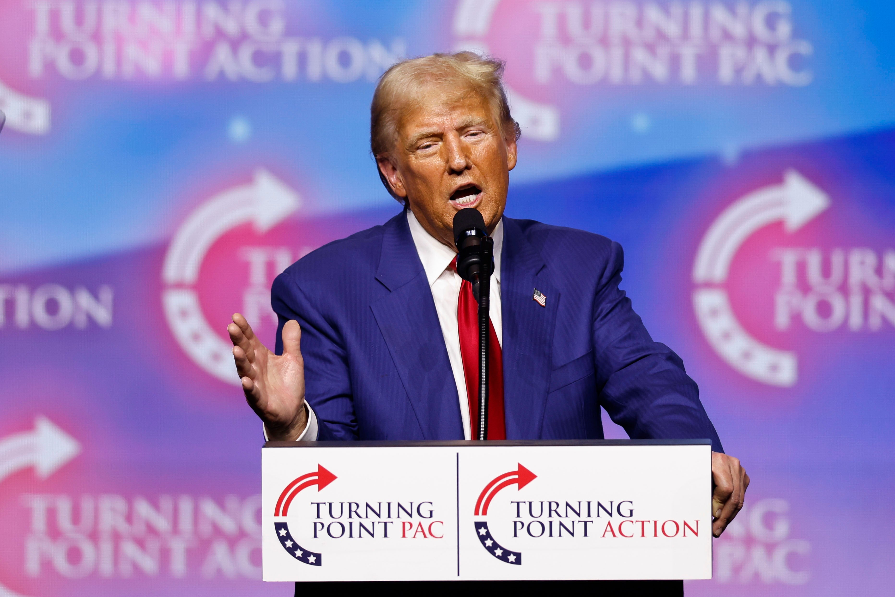 Donald Trump said he’s leading by ‘a lot’ in three key swing states, despite polling that shows otherwise, at a Turning Point PAC campaign rally on Thursday night