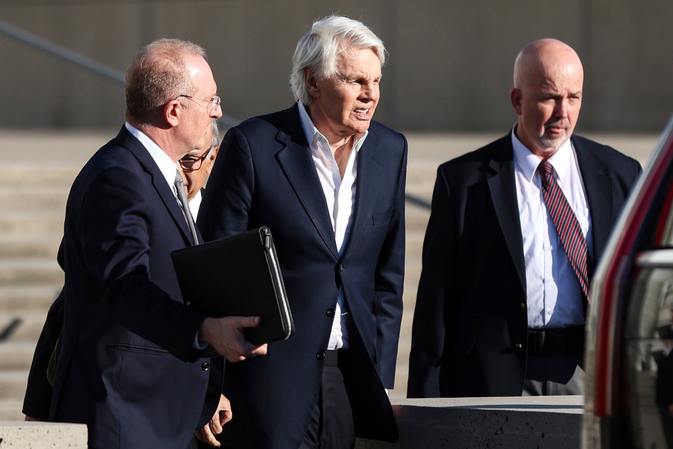 Michael Jeffries, centre, exits the federal courthouse (Heather Khalifa/AP)