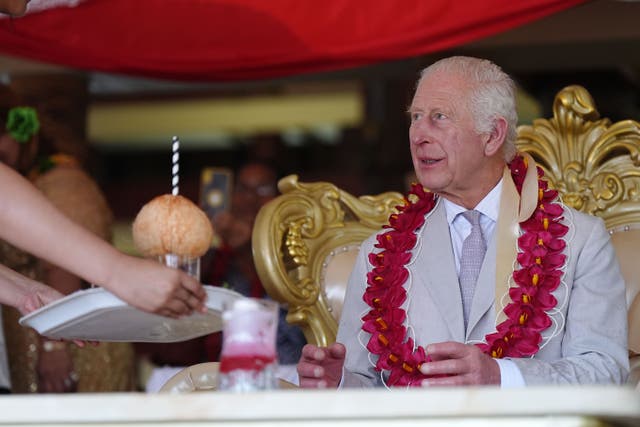 The King is presented with a drink during a farewell ceremony (Aaron Chown/PA)