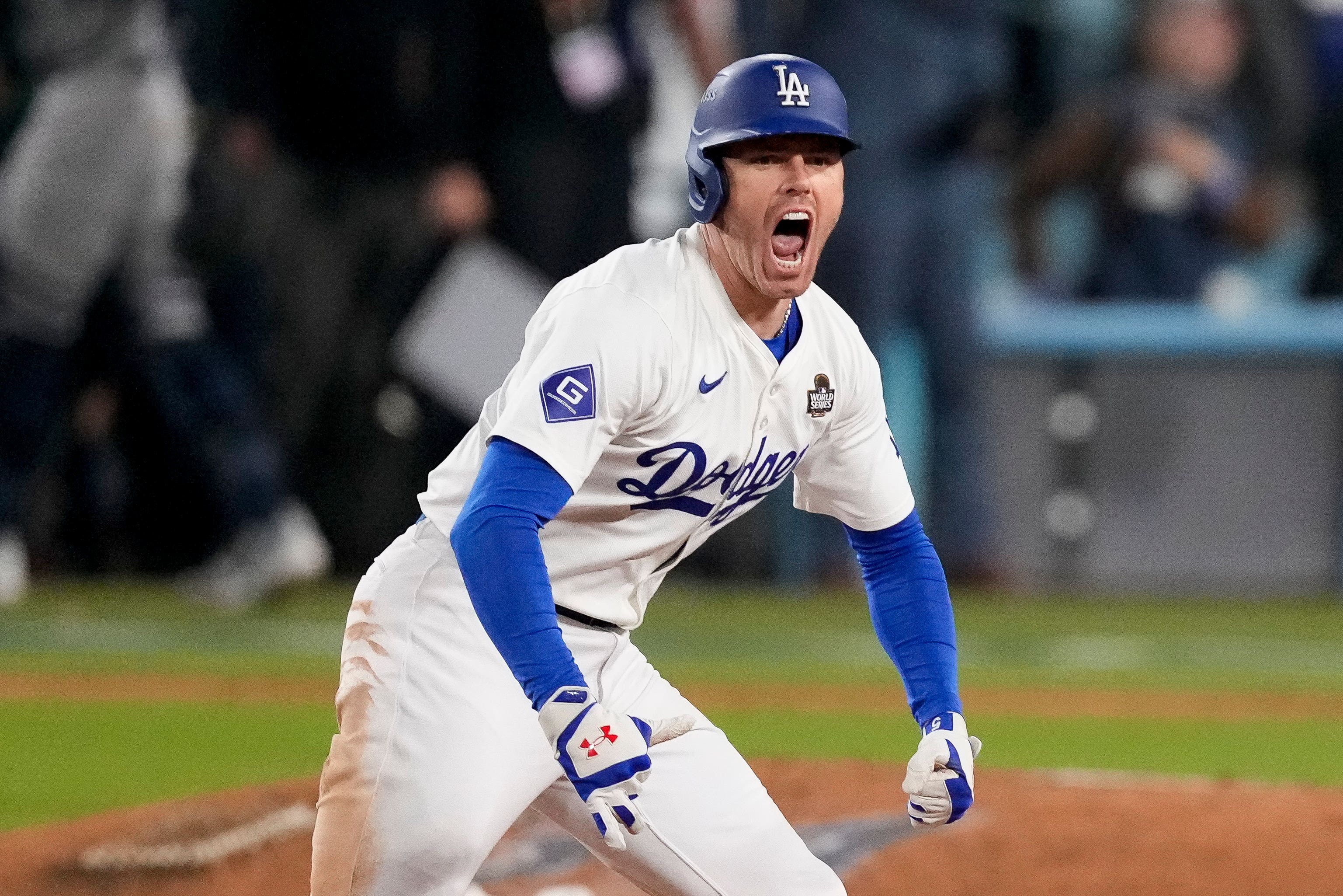 Los Angeles Dodgers’ Freddie Freeman celebrates after hitting a walk-off grand slam home run during the 10th inning (Mark J Terrill/AP)