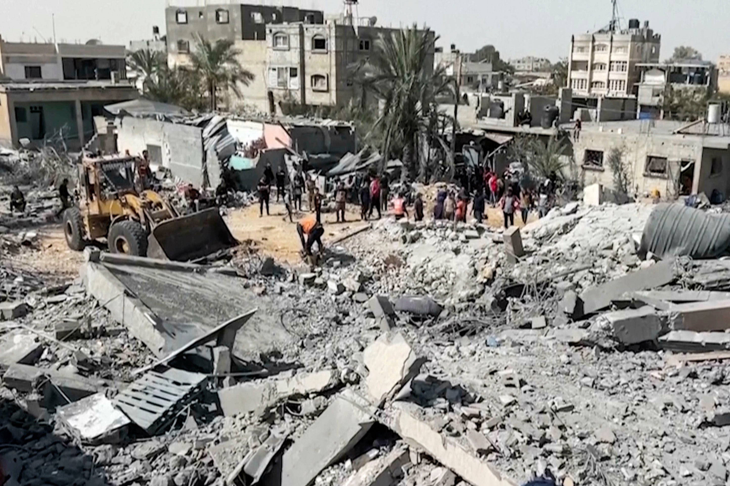 Palestinians gather near a building destroyed by Israeli airstrikes in the city of Khan Younis, southern Gaza Strip, Friday, 25 October 2024