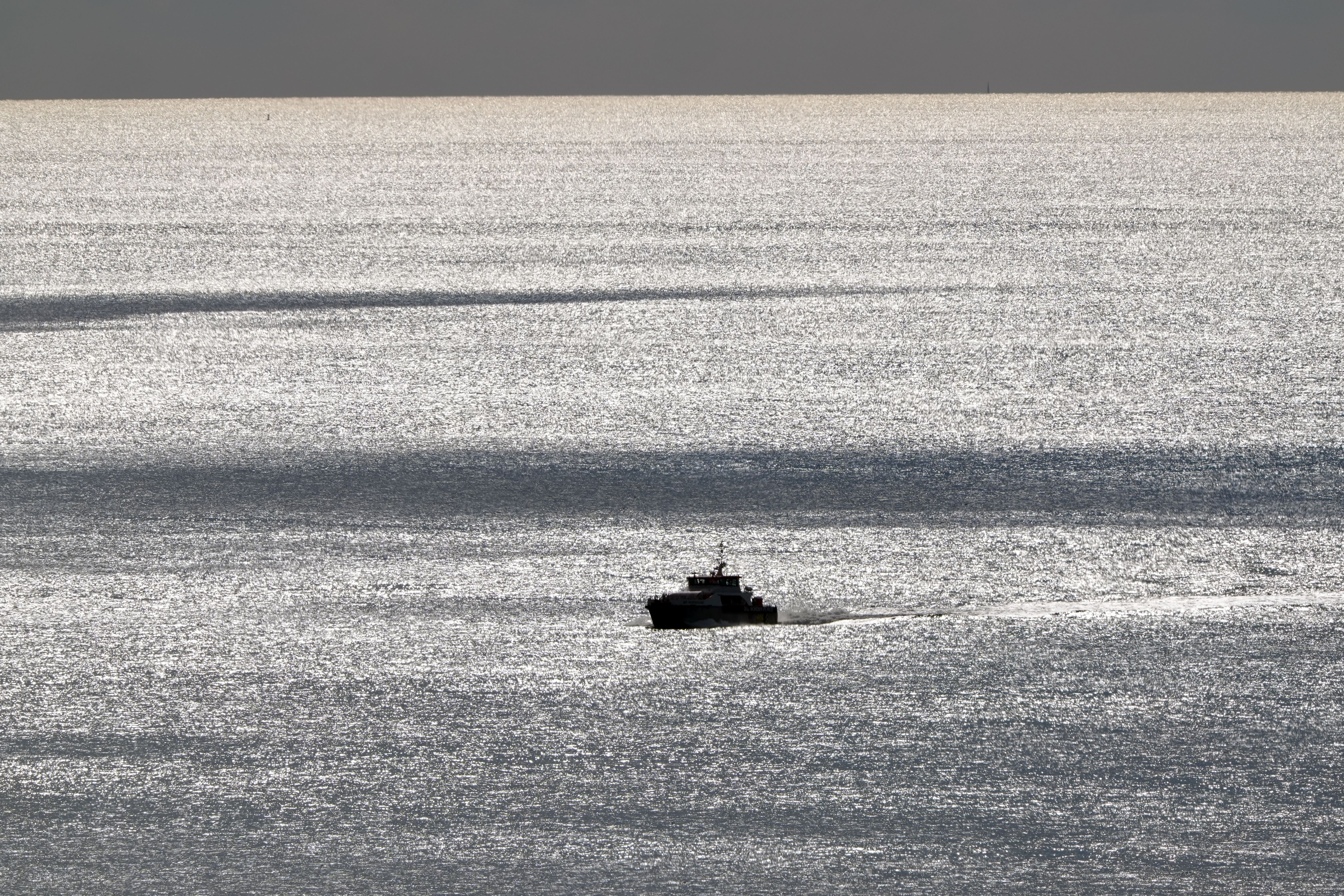 A group of people thought to be migrants are brought in to Dover, Kent, onboard a Border Force vessel following a small boat incident in the Channel (PA)