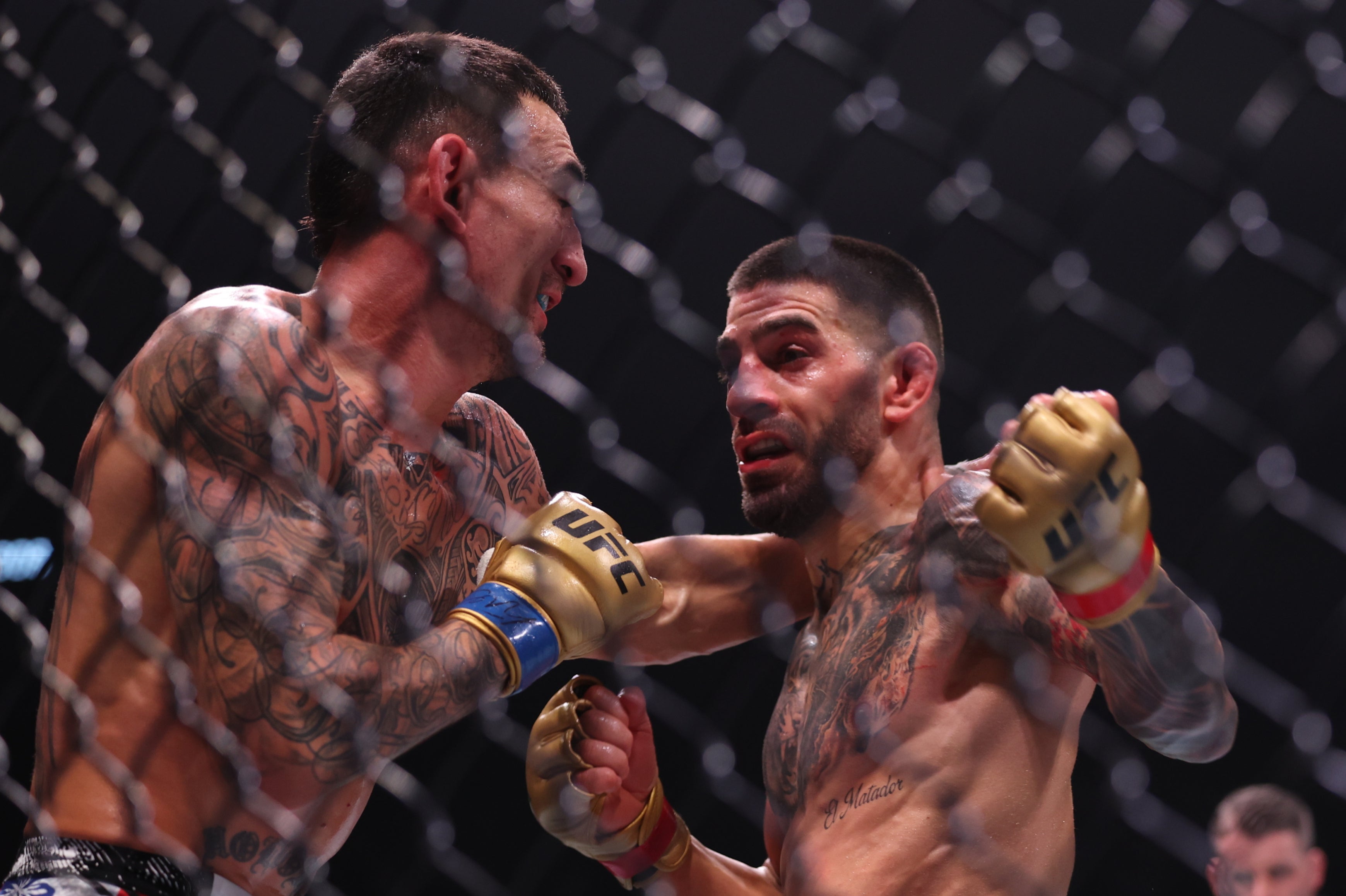 Ilia Topuria (right) knocked out Max Holloway with a left hook to retain his title