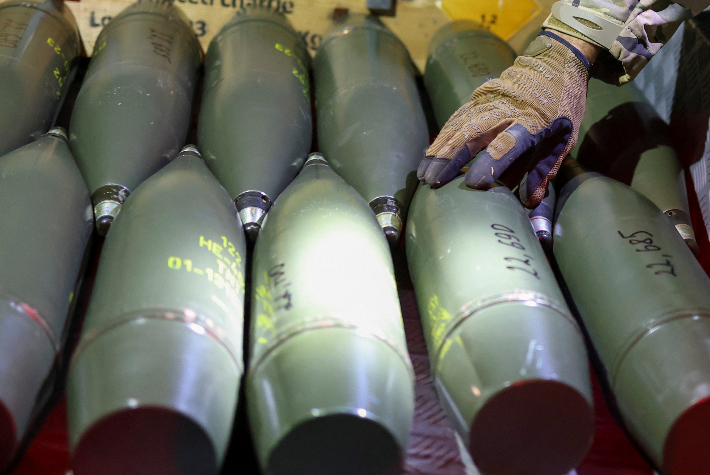 Ukrainian serviceman cheks artillery shells at his position in a front line in Southern Ukraine