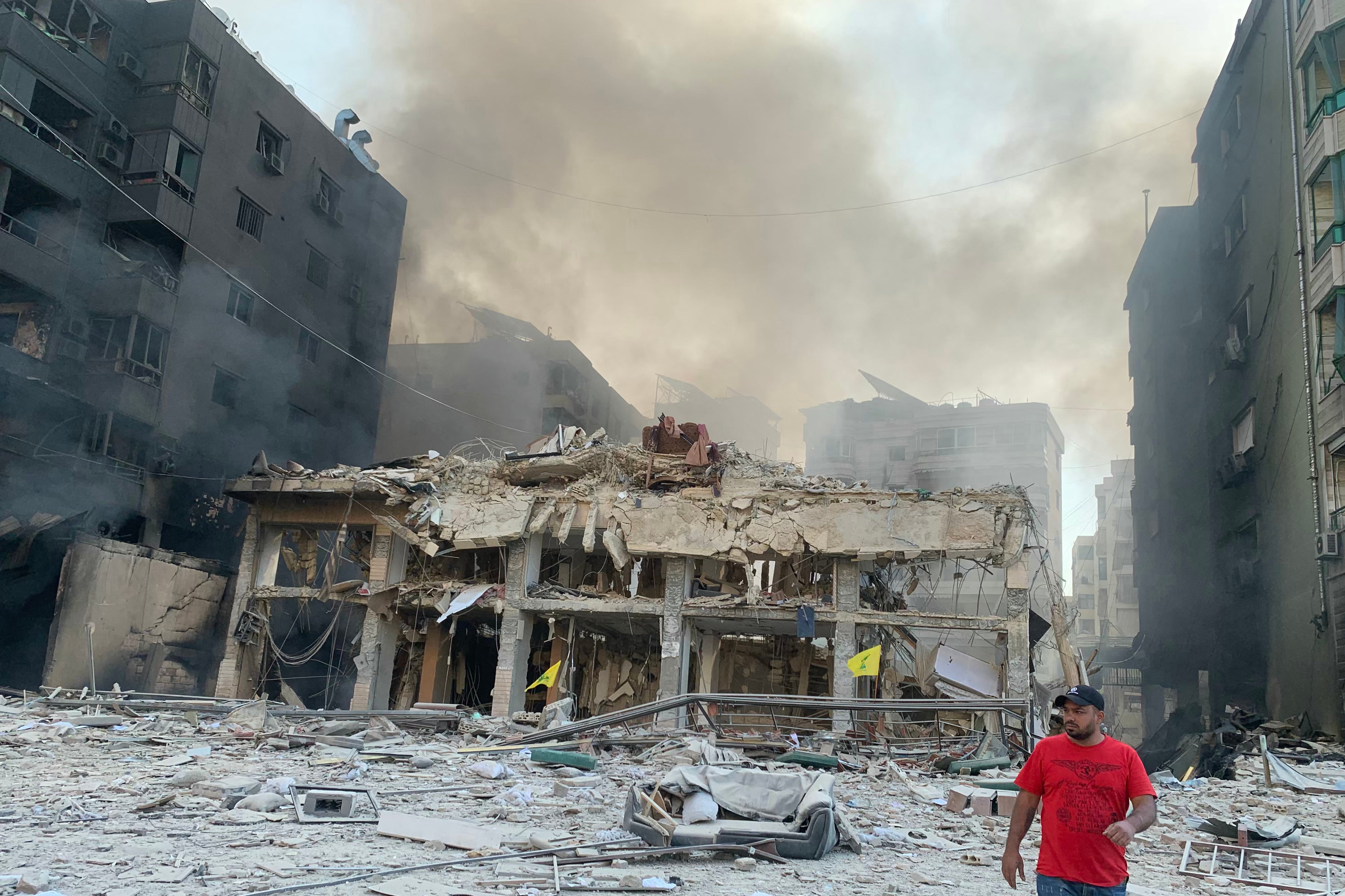 A man inspects the debris and damage at the site of overnight Israeli airstrikes that targeted Beirut’s southern suburb of Hadath on 27 October 2024