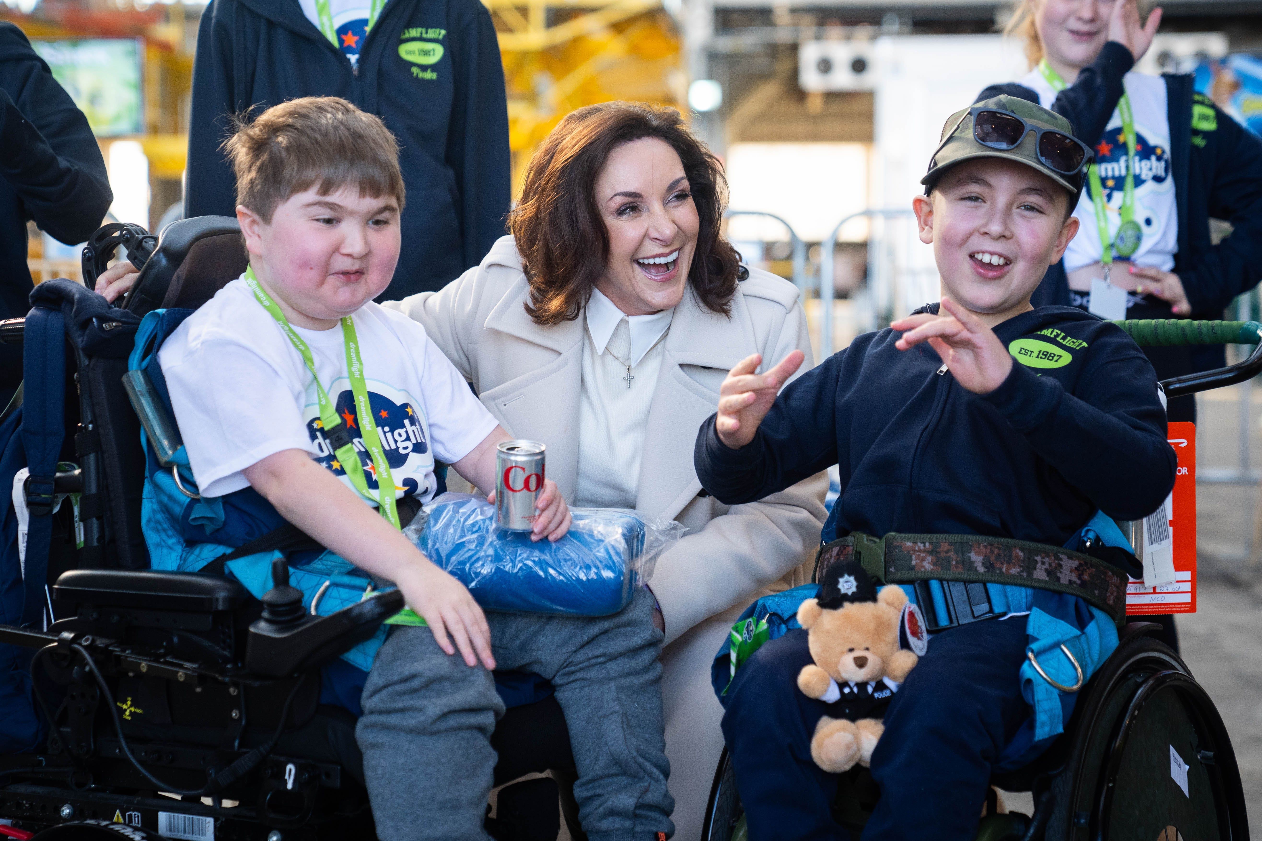 Shirley Ballas speaks with children at a hangar party at Heathrow Airport in London, as part of the Dreamflight charity trip to Florida (James Manning/PA)