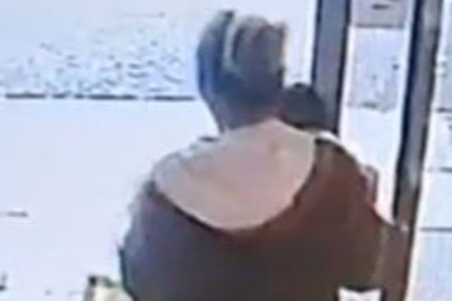 <p>Anka seen leaving a Travelodge hotel in Luton holding a baby </p>