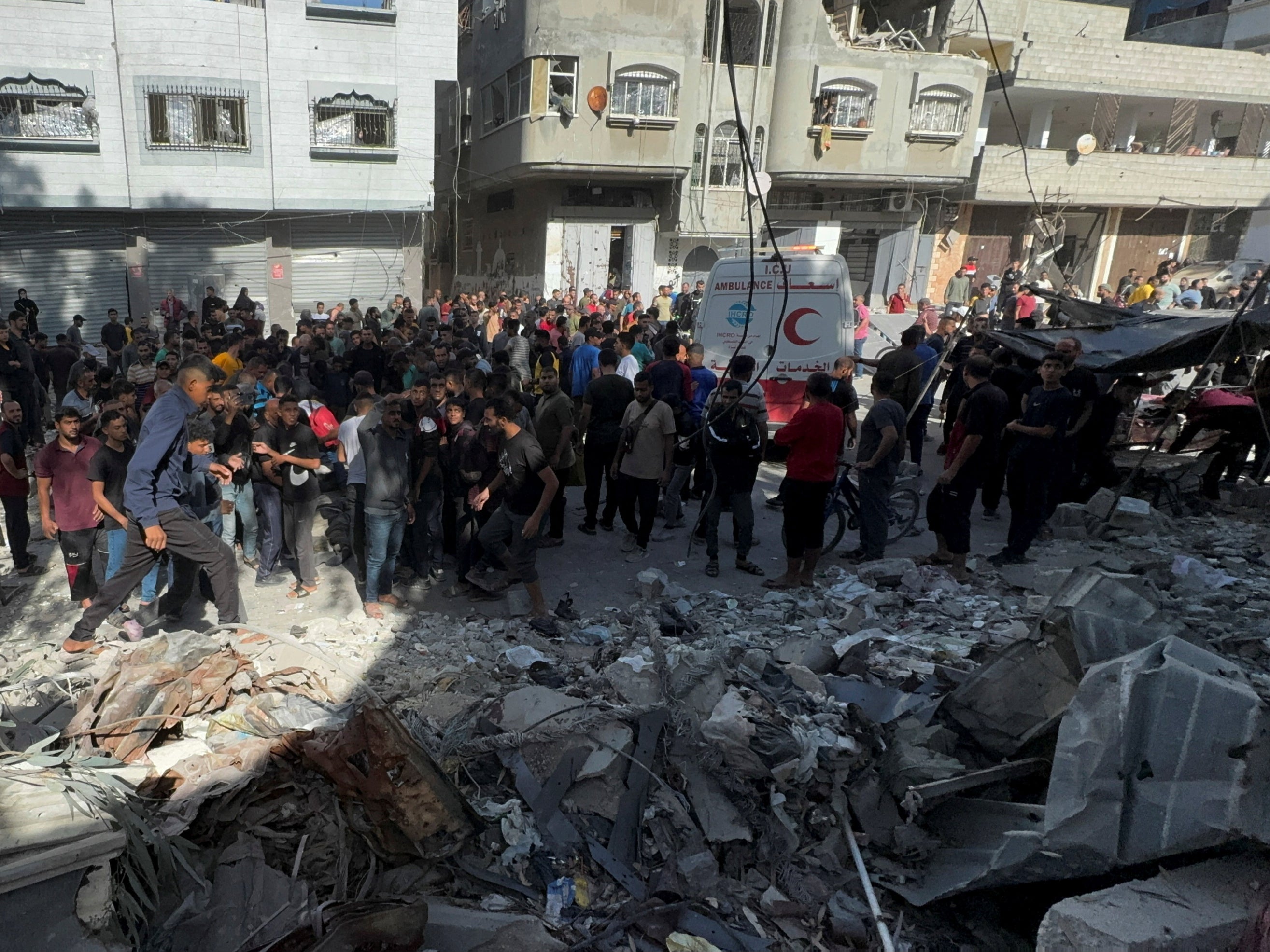 Palestinians inspect the site of an Israeli strike on a school sheltering displaced people in Gaza City over the weekend