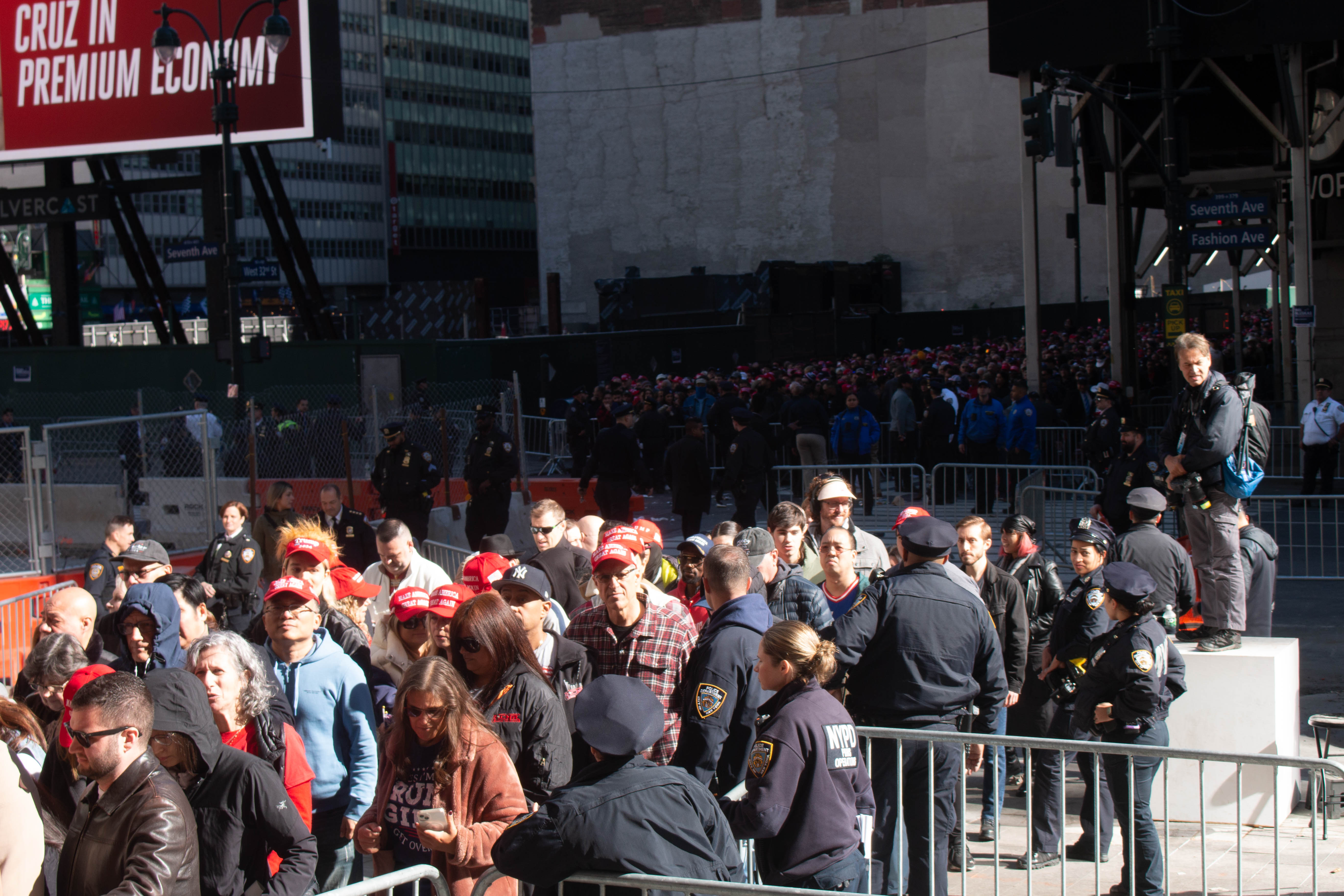 Police usher hundreds of Trump supporters from 32nd Street into the entrance of Madison Square Garden on Sunday afternoon