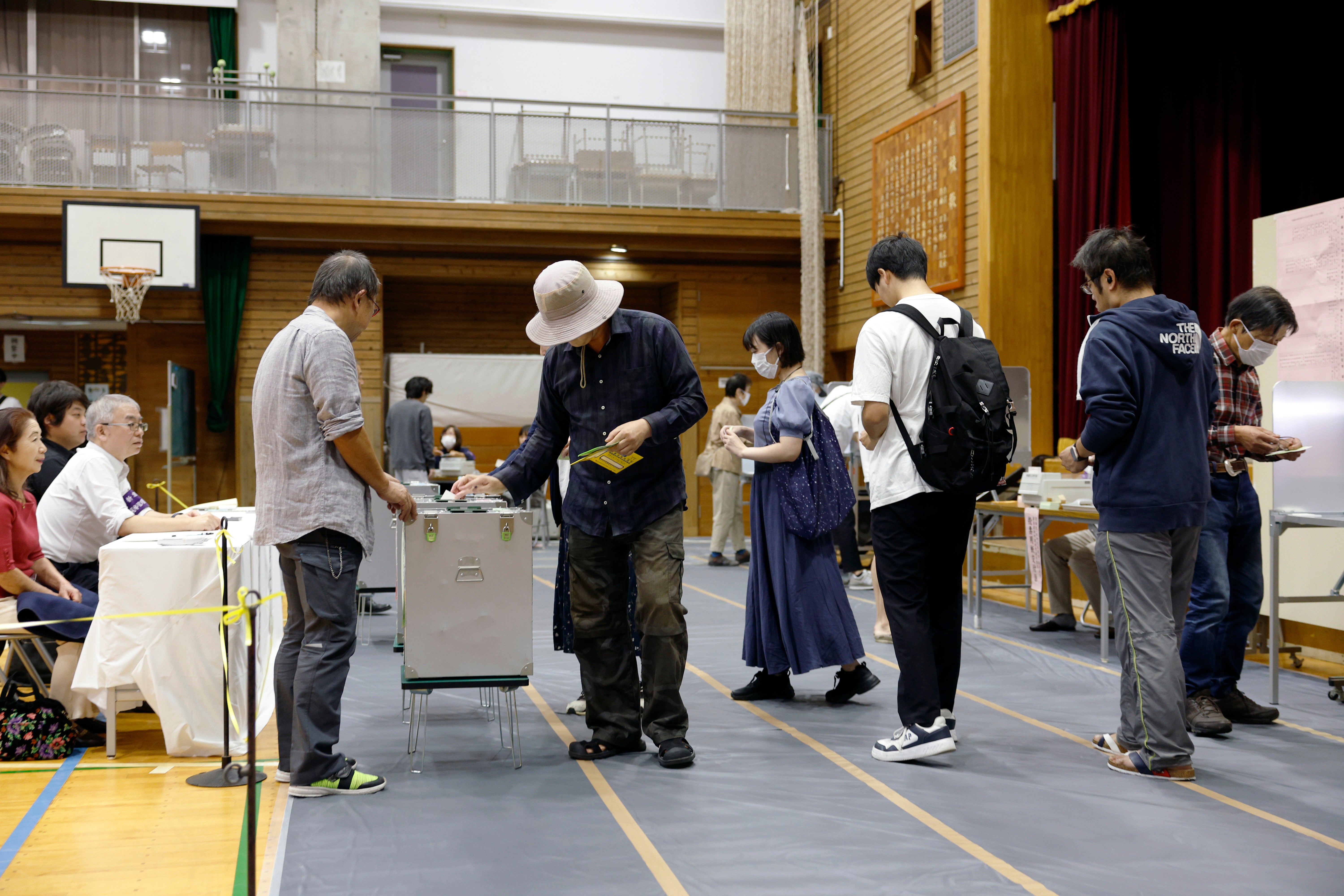 People vote during the general election at a polling station in Tokyo on Sunday