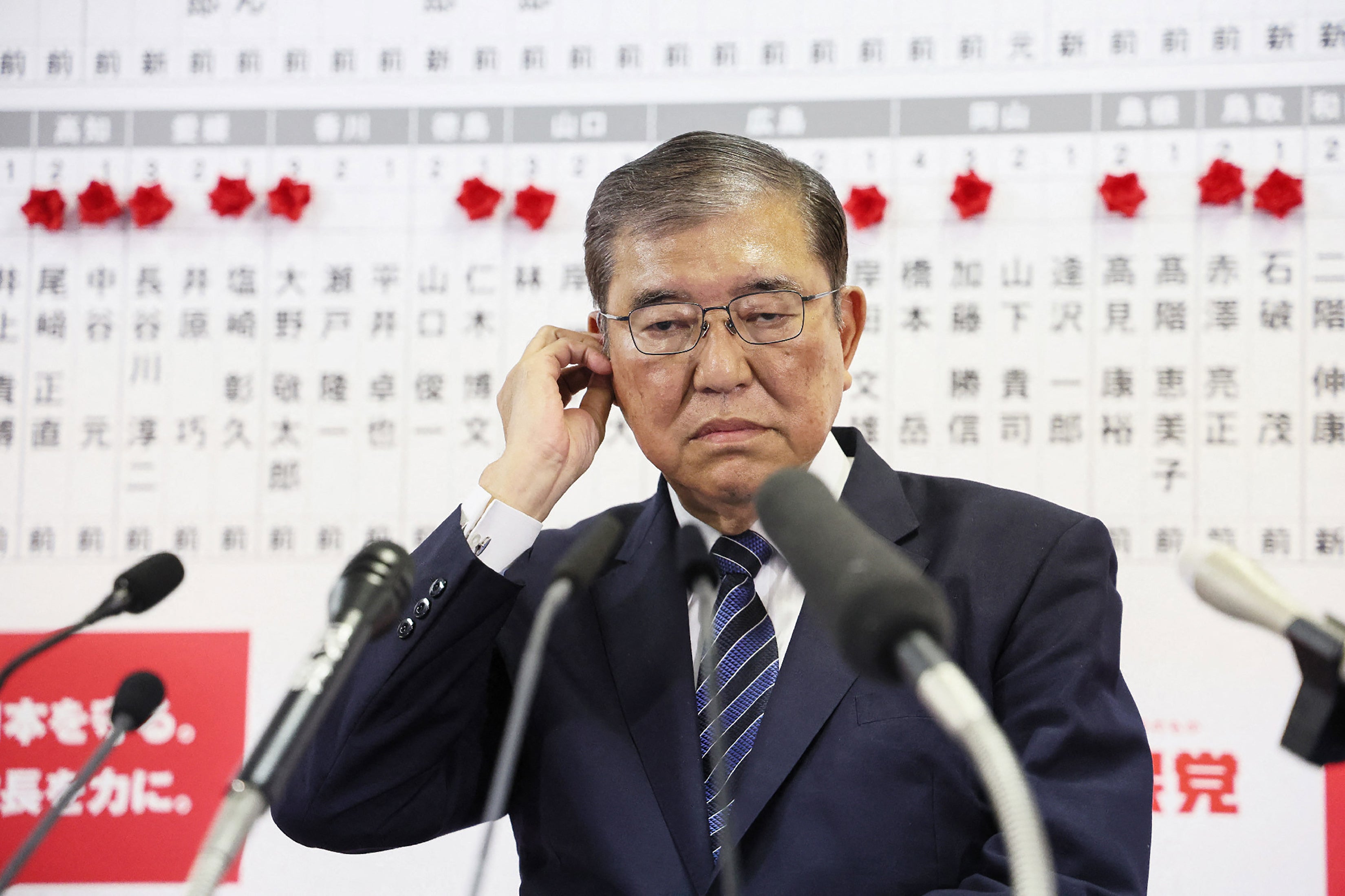 Prime minister Shigeru Ishiba reacts to the election results in a press conference at LDP party headquarters