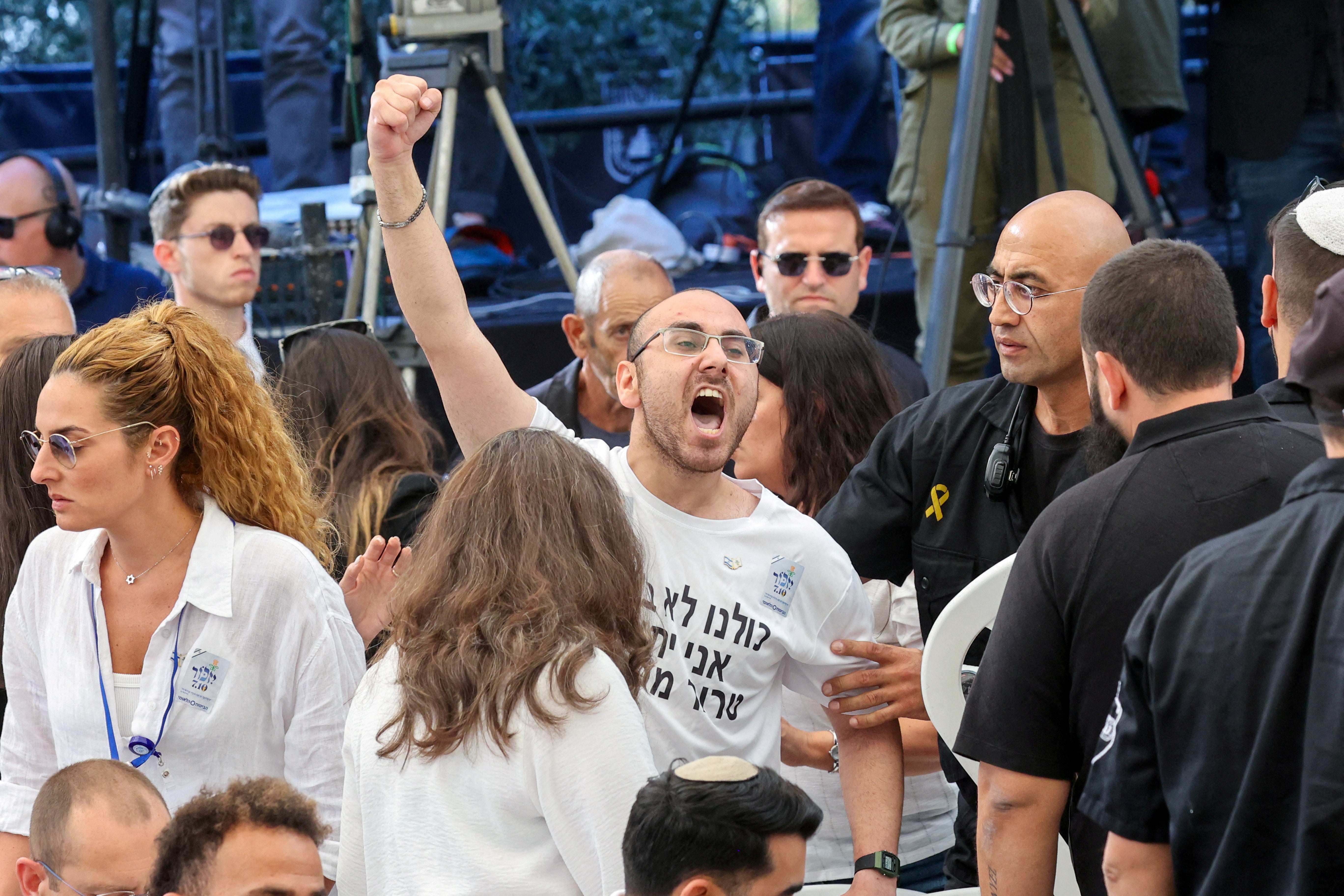 A man shouts as Israeli prime minister Benjamin Netanyahu speaks during a memorial ceremony of the Hamas attack