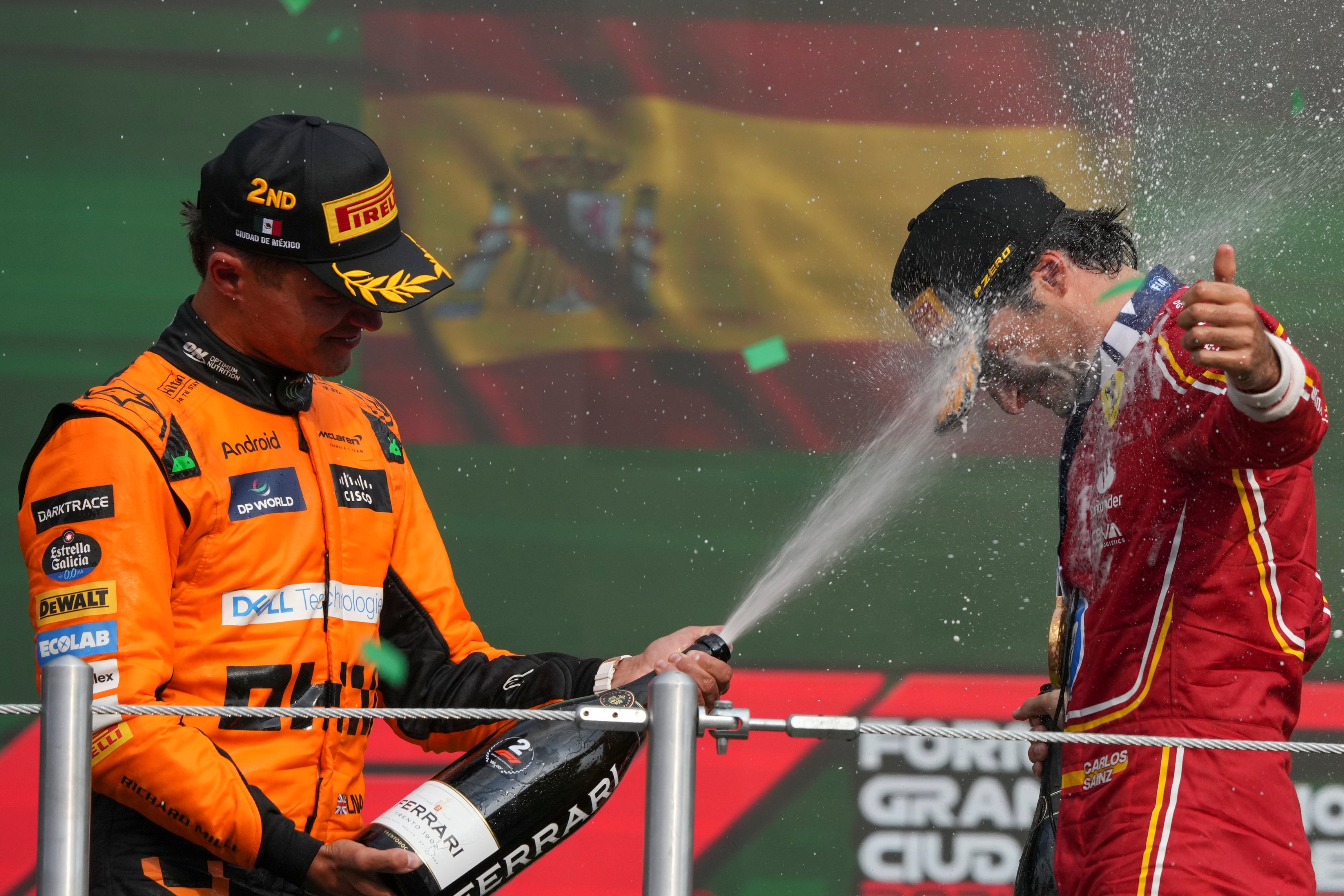 Lando Norris sprays Carlos Sainz in Mexico (AP Photo/Fernando Llano)