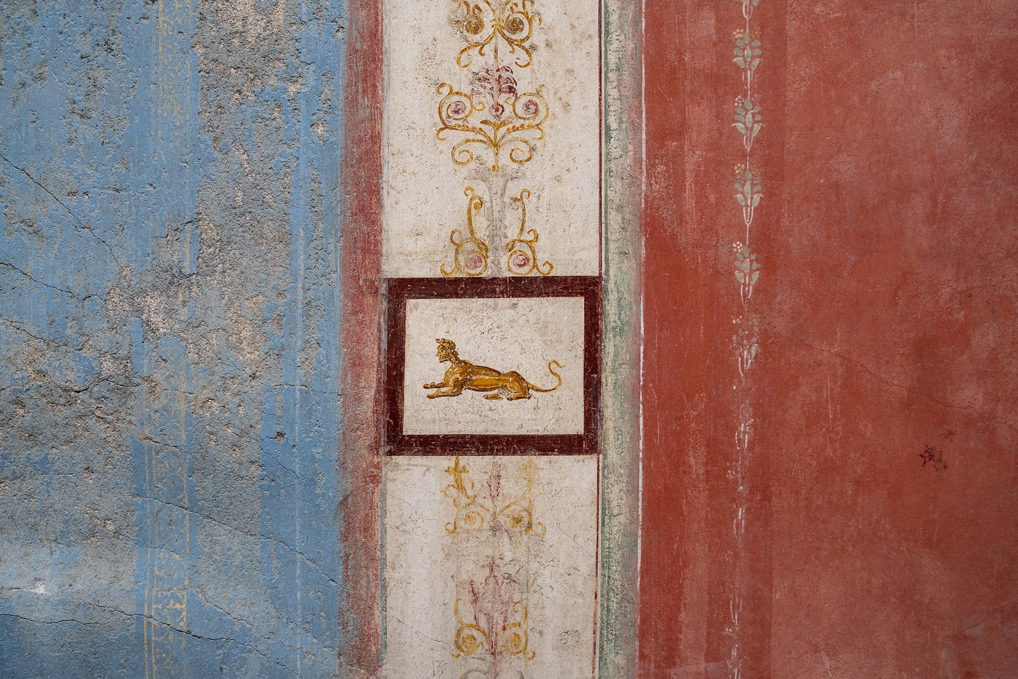 A sphynx, another mythical creature, lies down in this small painted decoration.