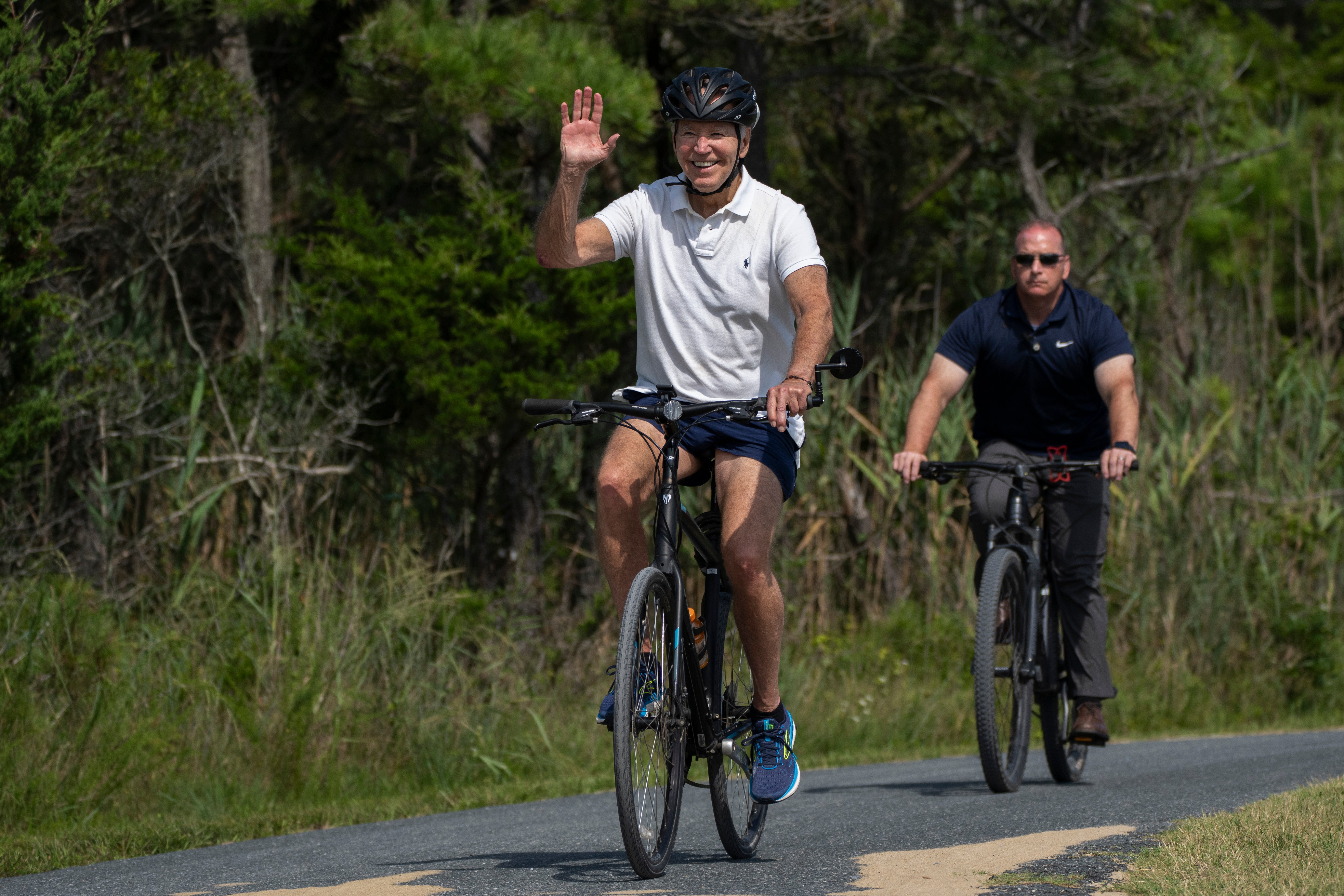 President Joe Biden with a Secret Service agent tailing behind him